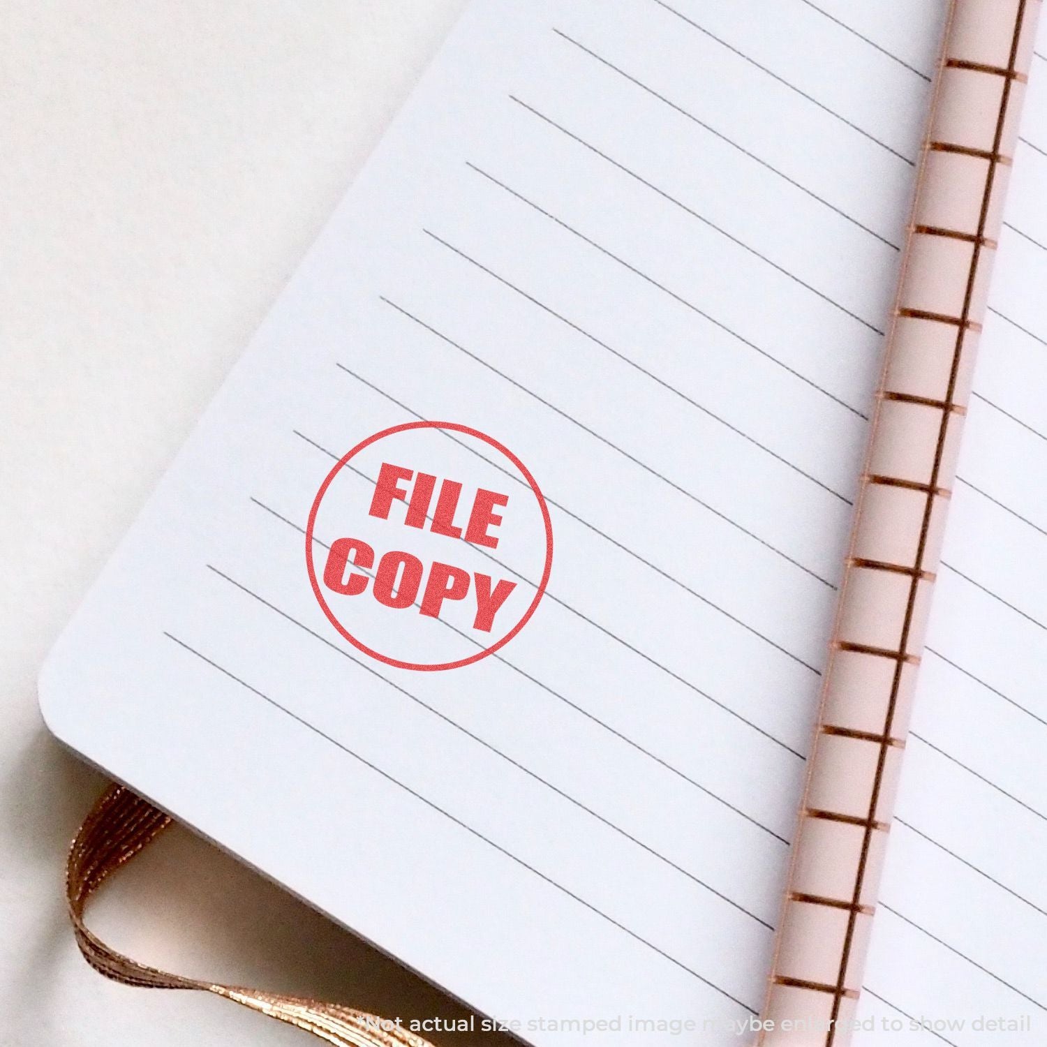 FILE COPY stamp on lined notebook page, highlighting document filing and copying for organized records.