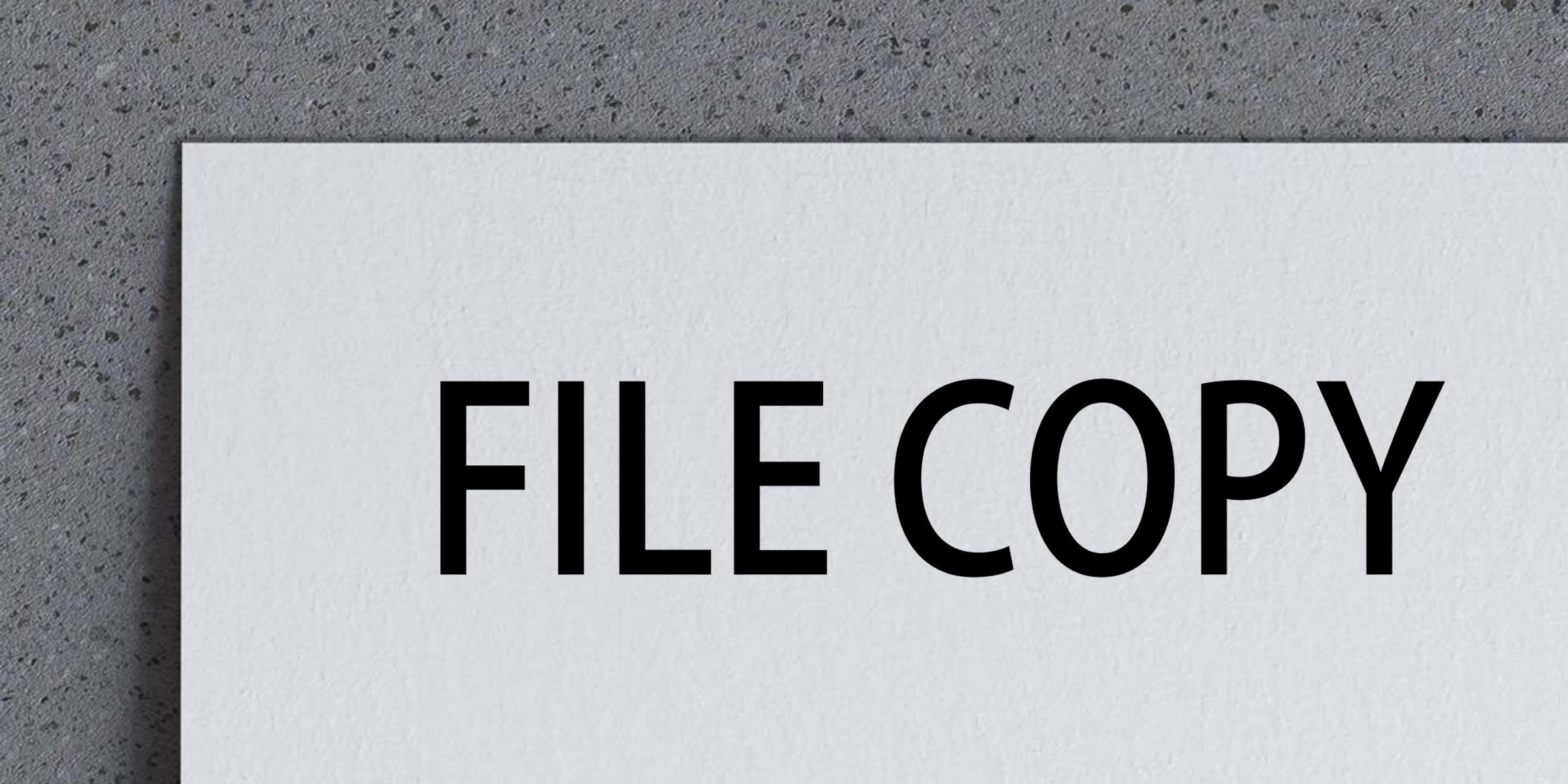 White paper labeled FILE COPY on a gray textured background, representing a document copy or duplicate file concept