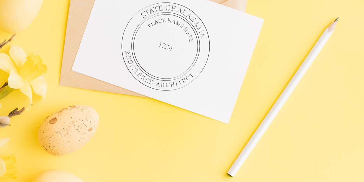 Alabama architect embossed seal on white paper with pencil and yellow flowers on yellow background, displaying the official Alabama architect seal meeting embossed seal standards.