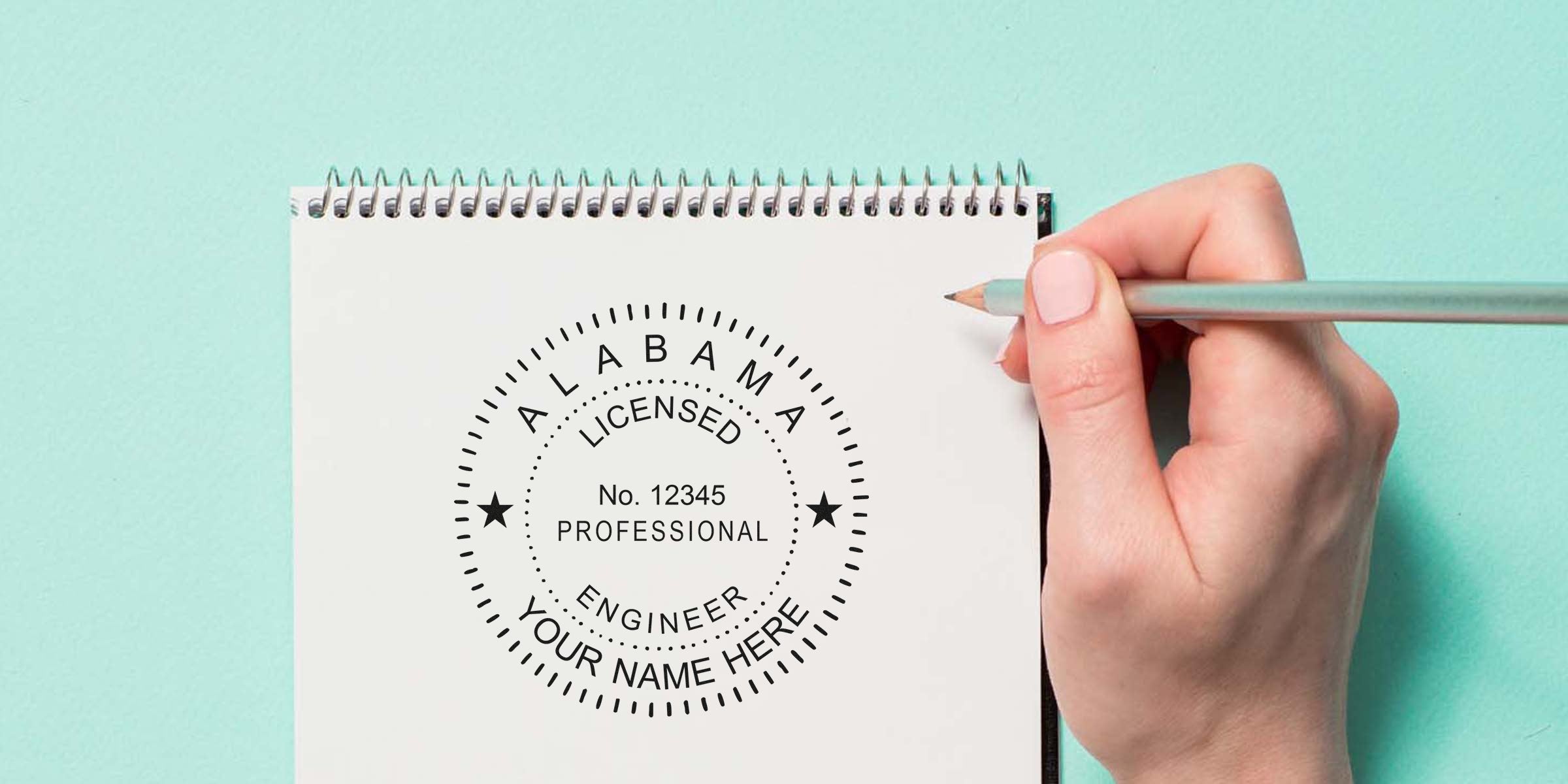 Alabama engineer stamps with a licensed professional engineer seal on a notebook, a hand holding a pencil beside custom engineer seals.