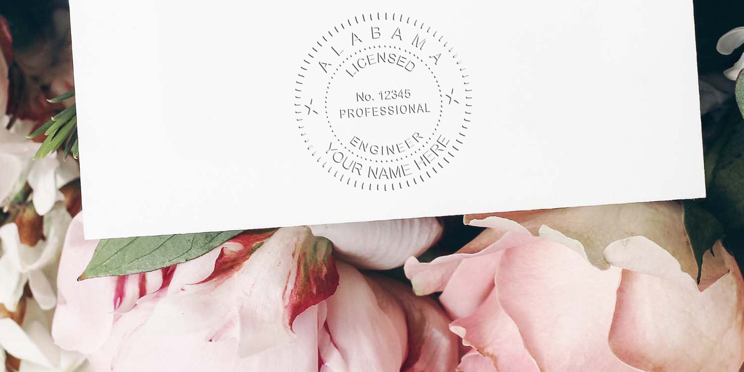 Alabama licensed professional engineer seal on white paper with pink and white flowers, illustrating Alabama engineer stamp regulations and professional engineer seal rules.