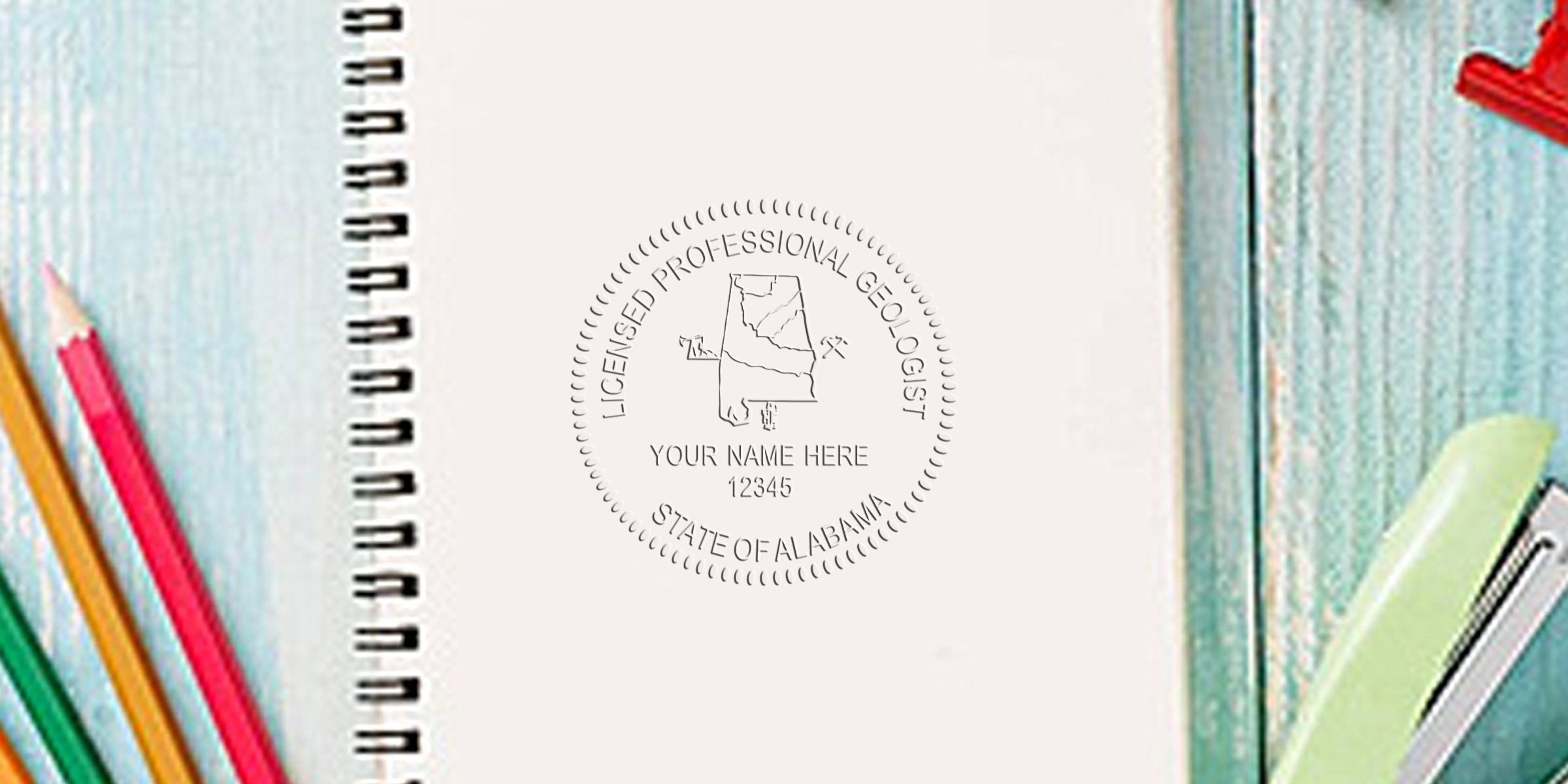Alabama geologist stamps with a licensed professional geologist stamp on a notebook, surrounded by colored pencils and a stapler on a wooden desk, showcasing collectible geological stamps.
