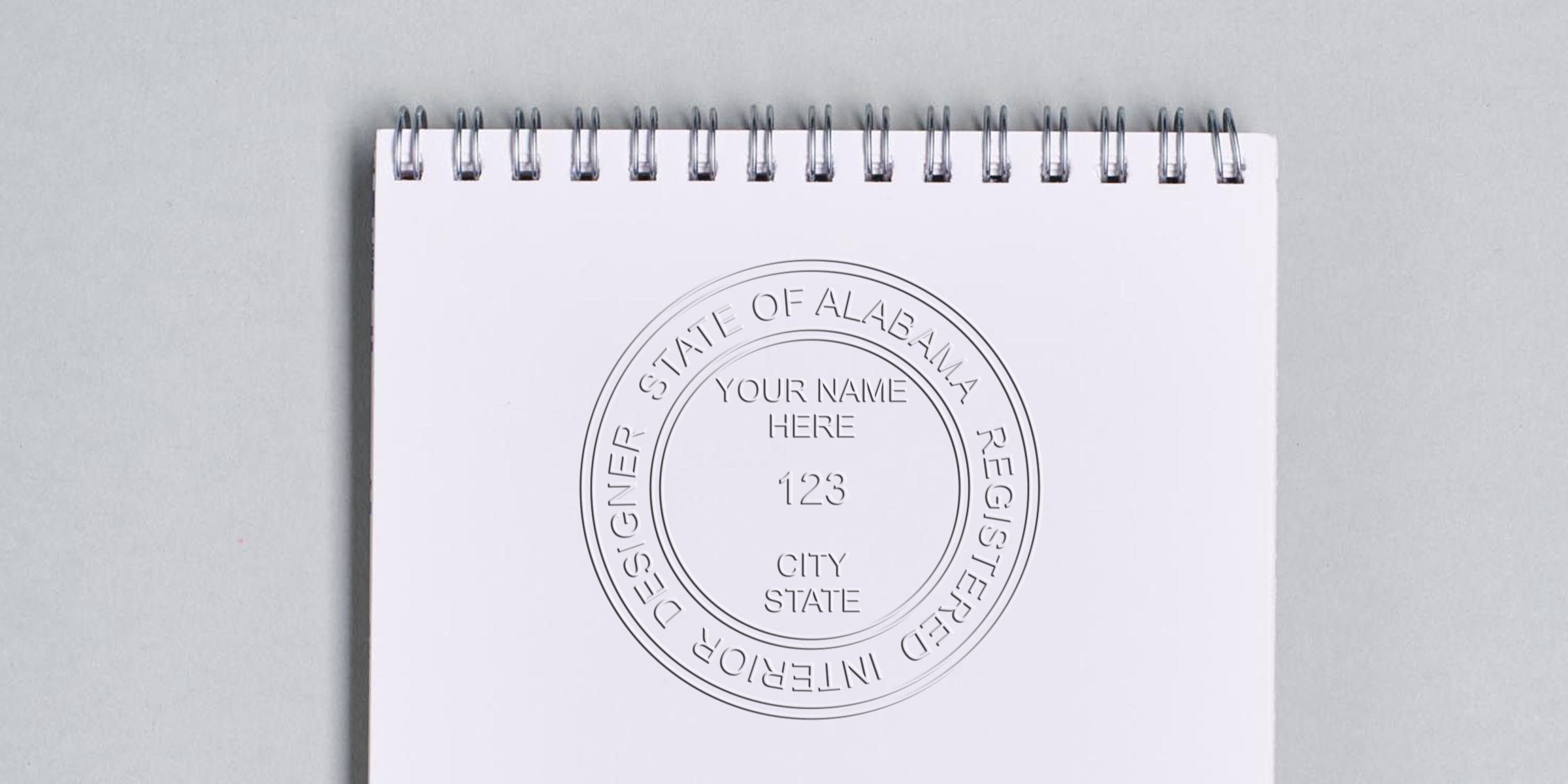 Alabama interior designer’s embossed seal on white spiral notebook for online shopping list.