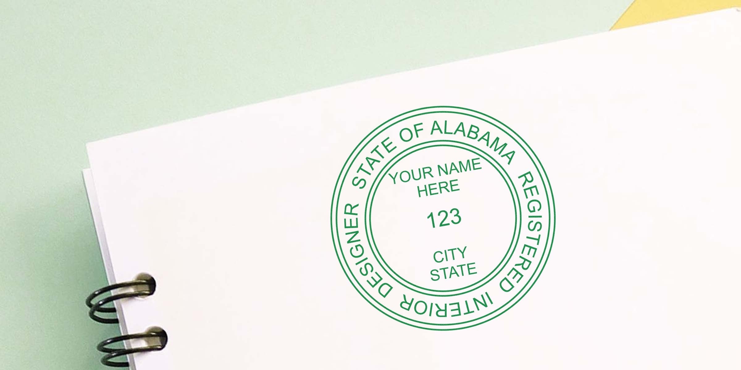 Alabama interior designer stamp on white spiral notebook, showing certification and tips for buying interior design stamps.