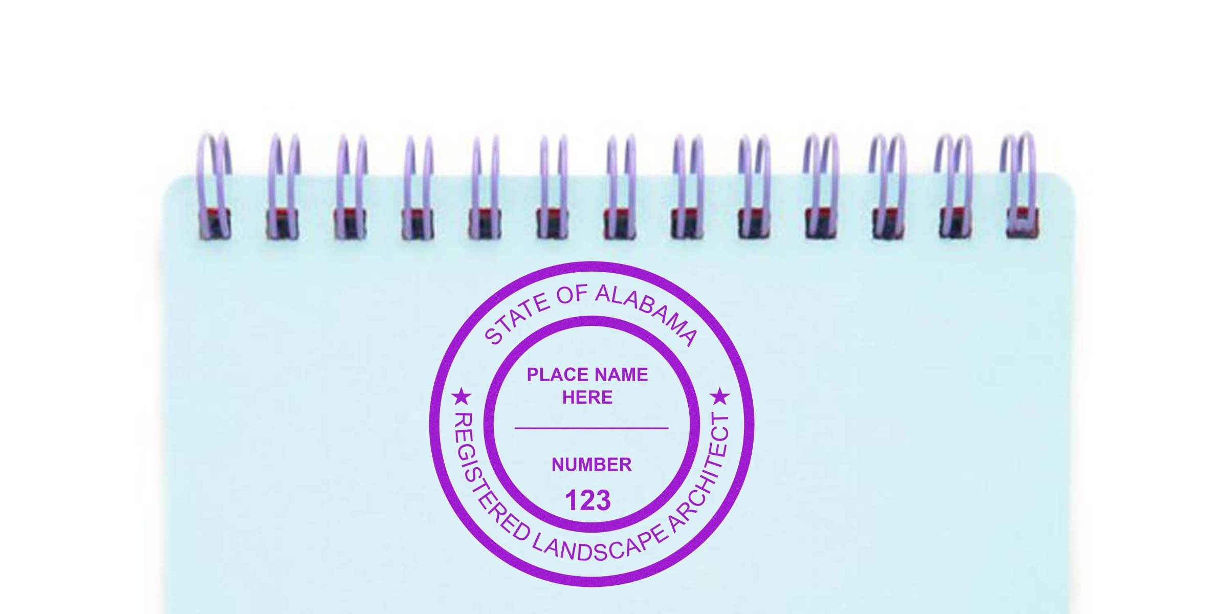 Custom Alabama landscape architect stamp on spiral notebook with place name and registration number.