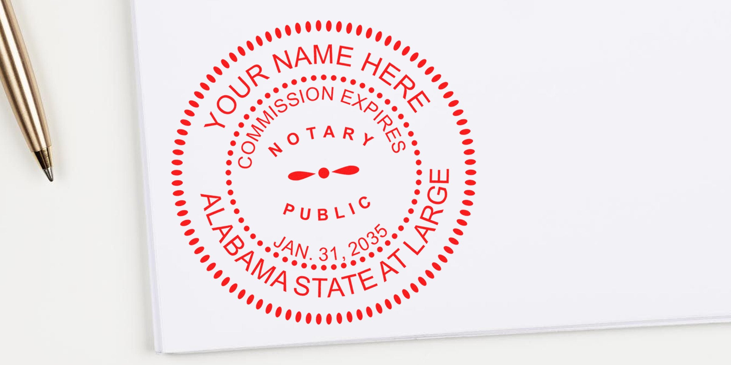 Alabama state at-large notary public stamp with AL seal and commission expiration date on white paper next to gold pen, following notary seal guidelines.