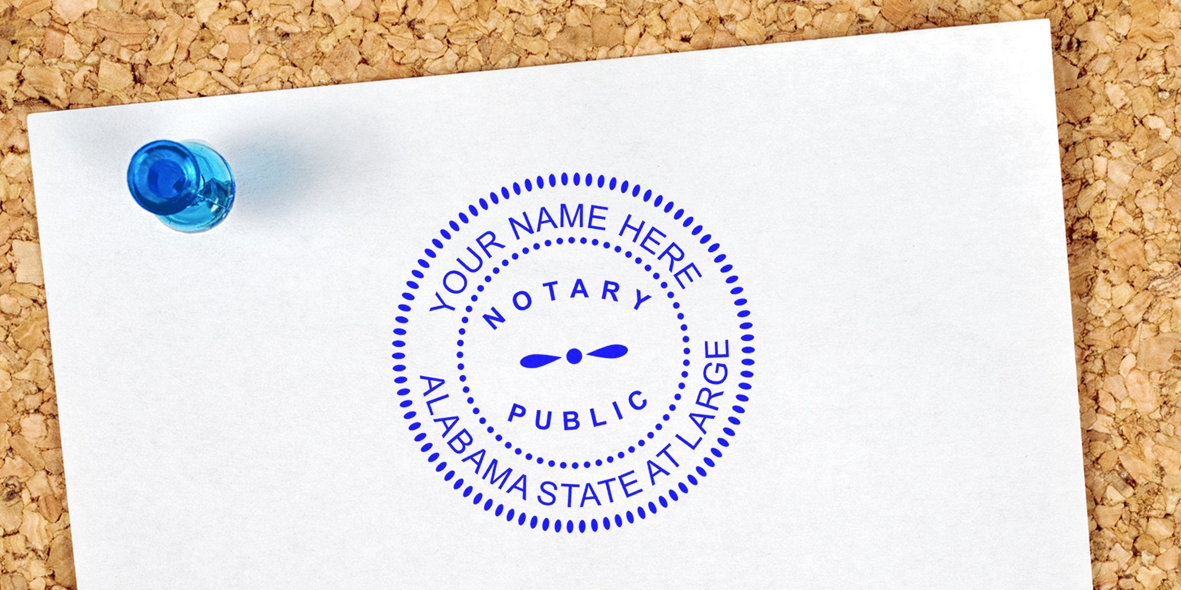 Alabama notary supplies with a notary public stamp on white paper pinned to a corkboard, displaying official tools and the Alabama state notary seal.