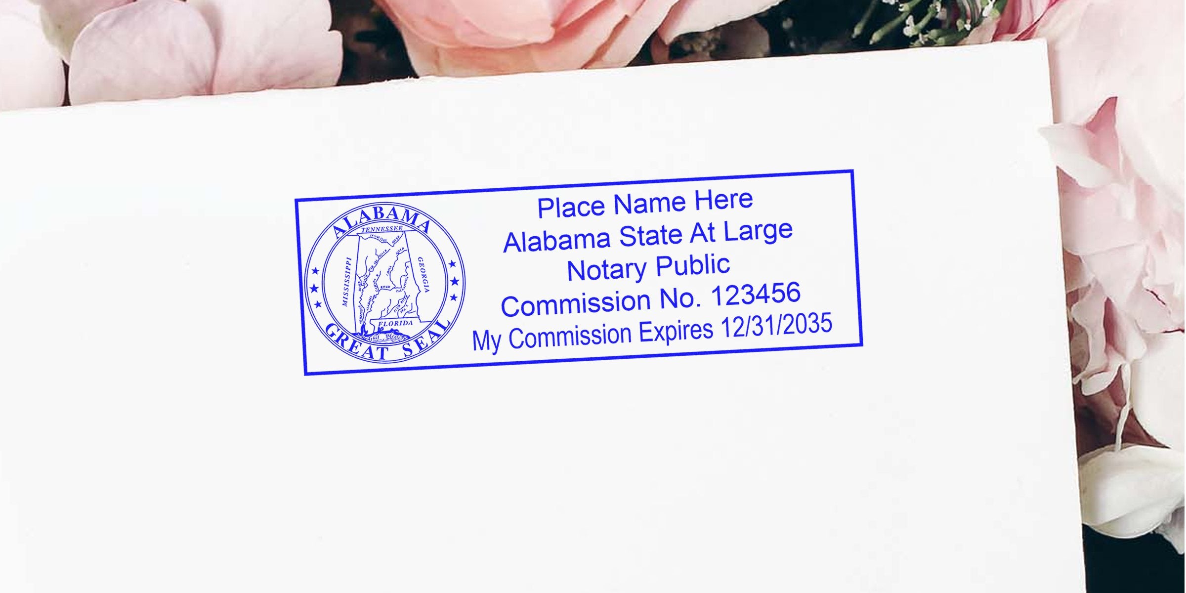 Alabama notary stamp on white envelope with pink flowers, showing official notary seal and commission details.