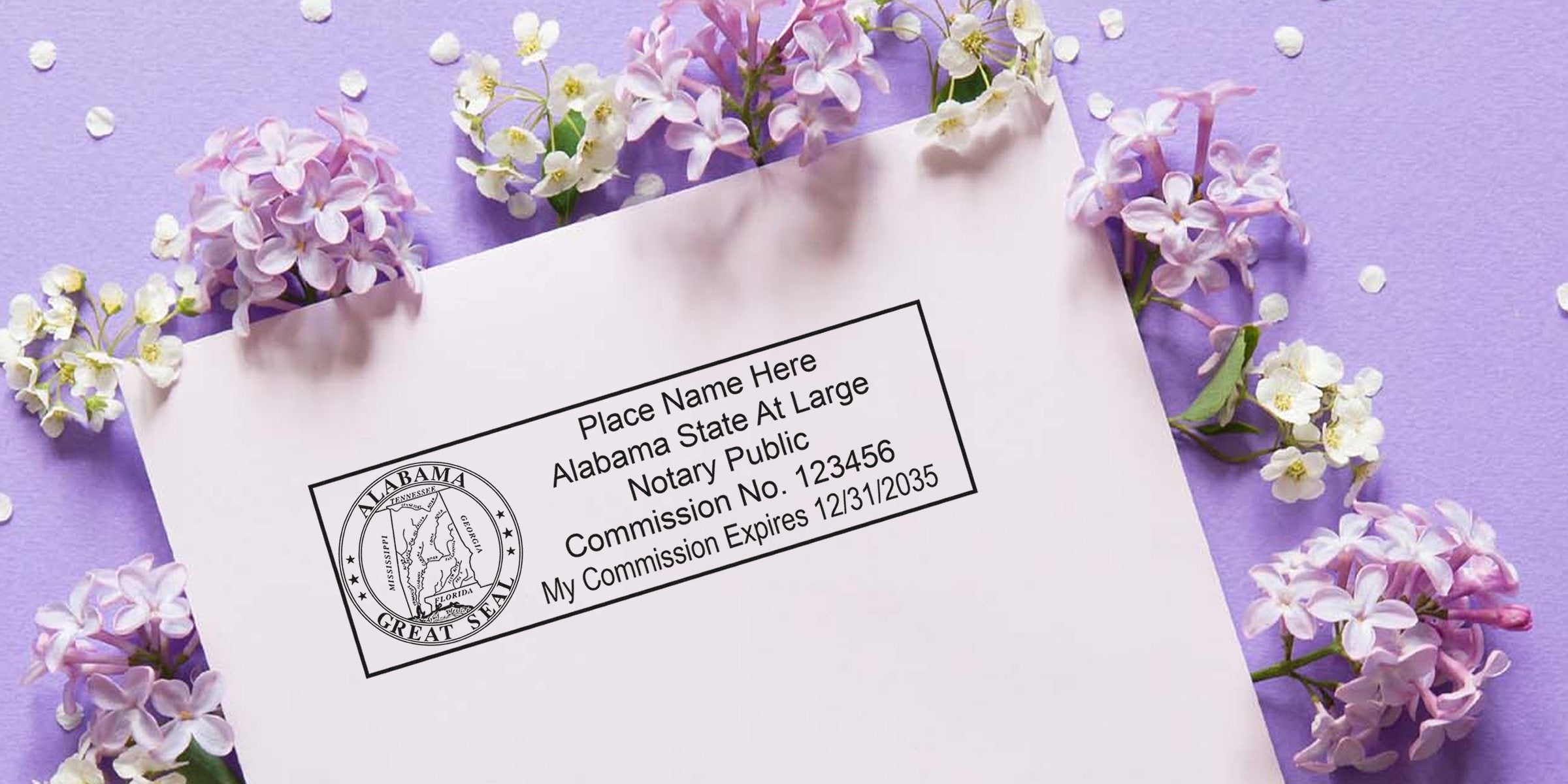 Alabama notary stamp on white paper, surrounded by purple lilac flowers, showing Alabama notary stamp and its requirements.