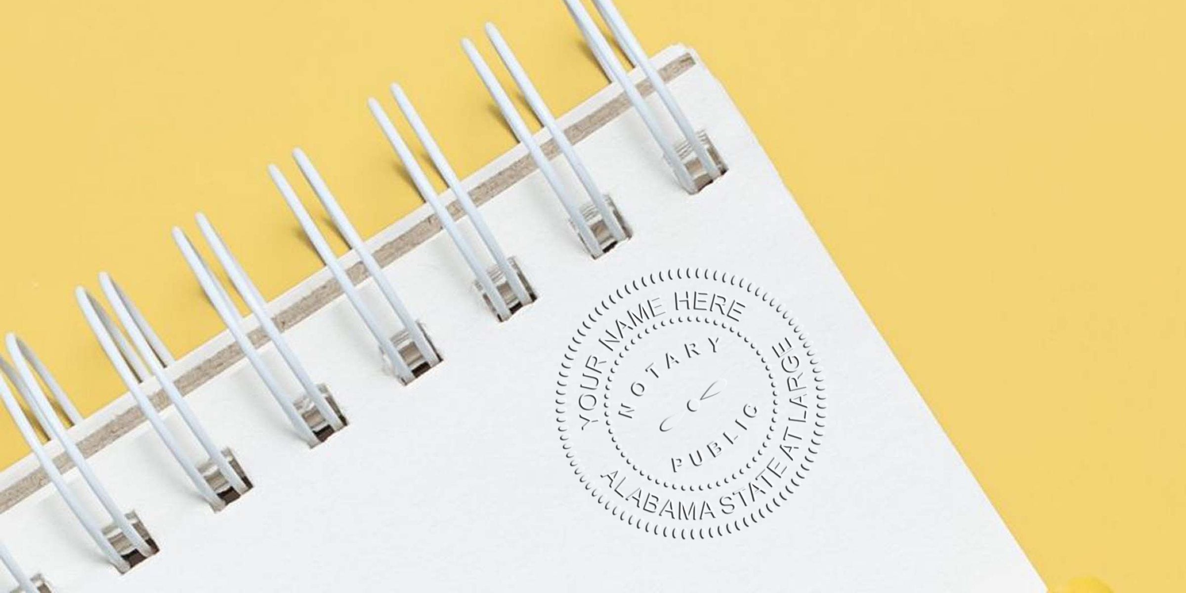 Alabama notary seal embossed on a spiral notebook, a key tool for official document verification by a notary public.