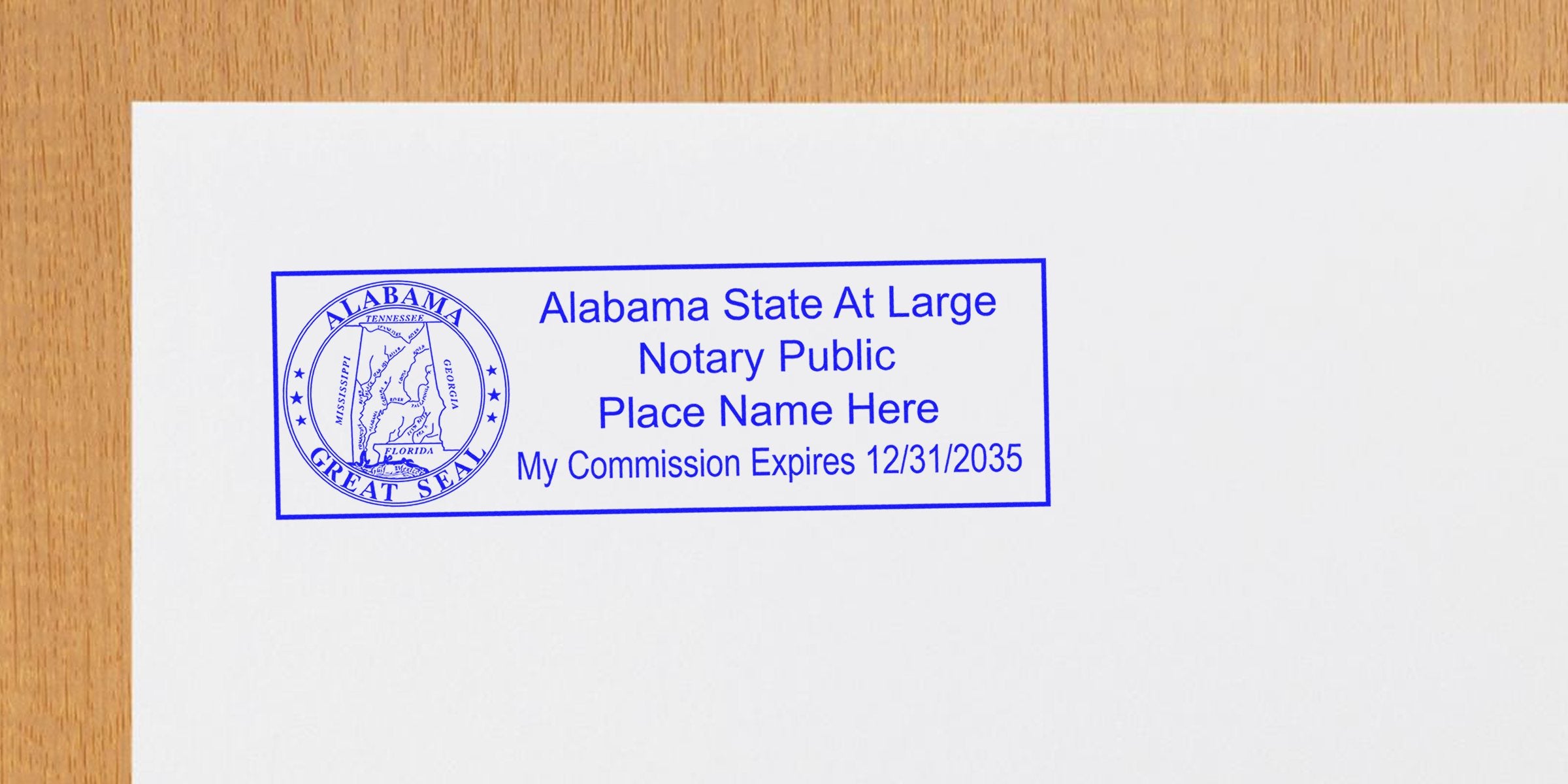 Alabama state at-large notary public stamp with commission expiration date on white paper, part of Alabama notary kit and supplies.
