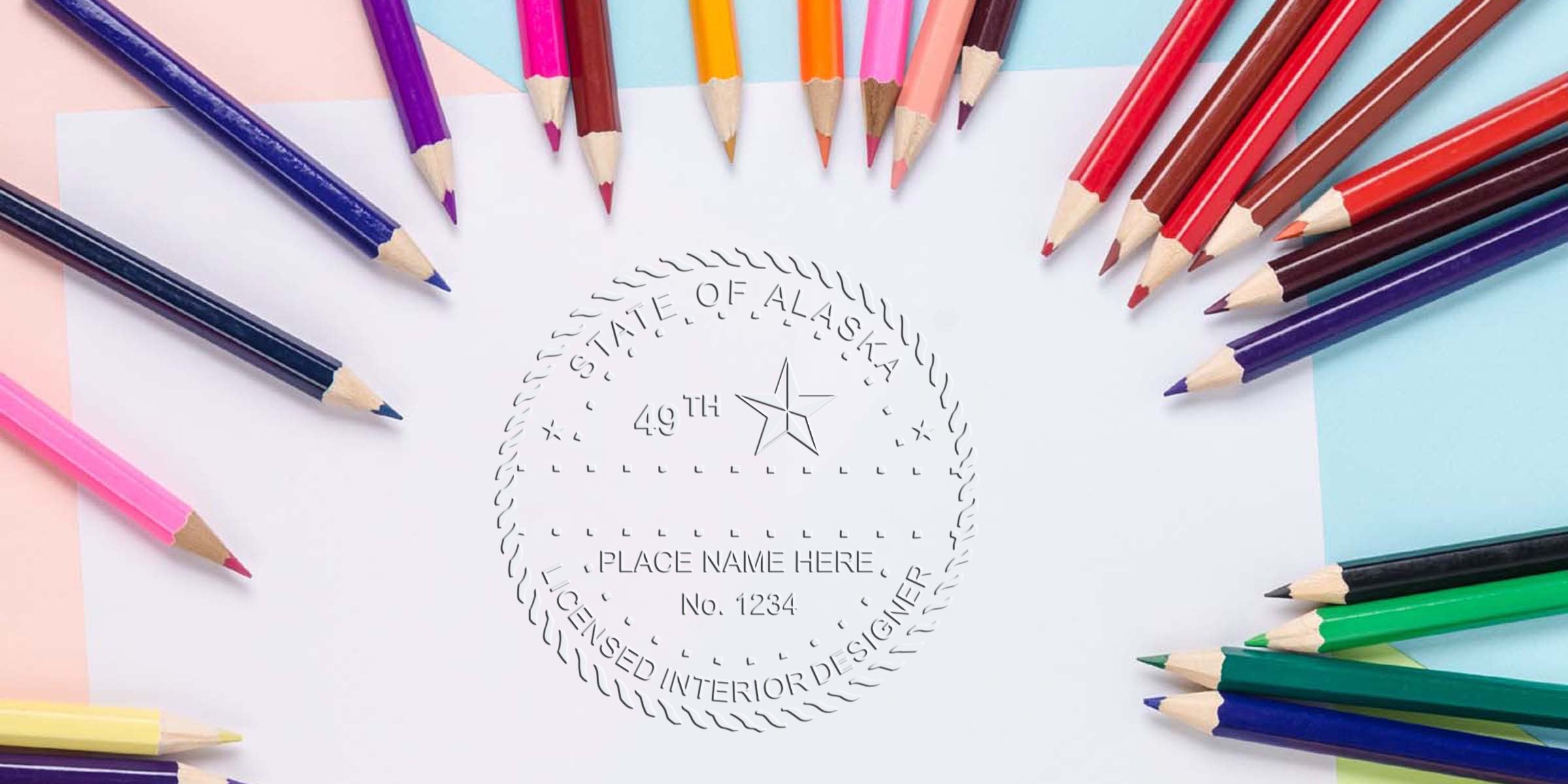 Colored pencils encircle an Alaska Interior Designer Stamp on white paper, showcasing the Interior Design Certification Alaska seal.