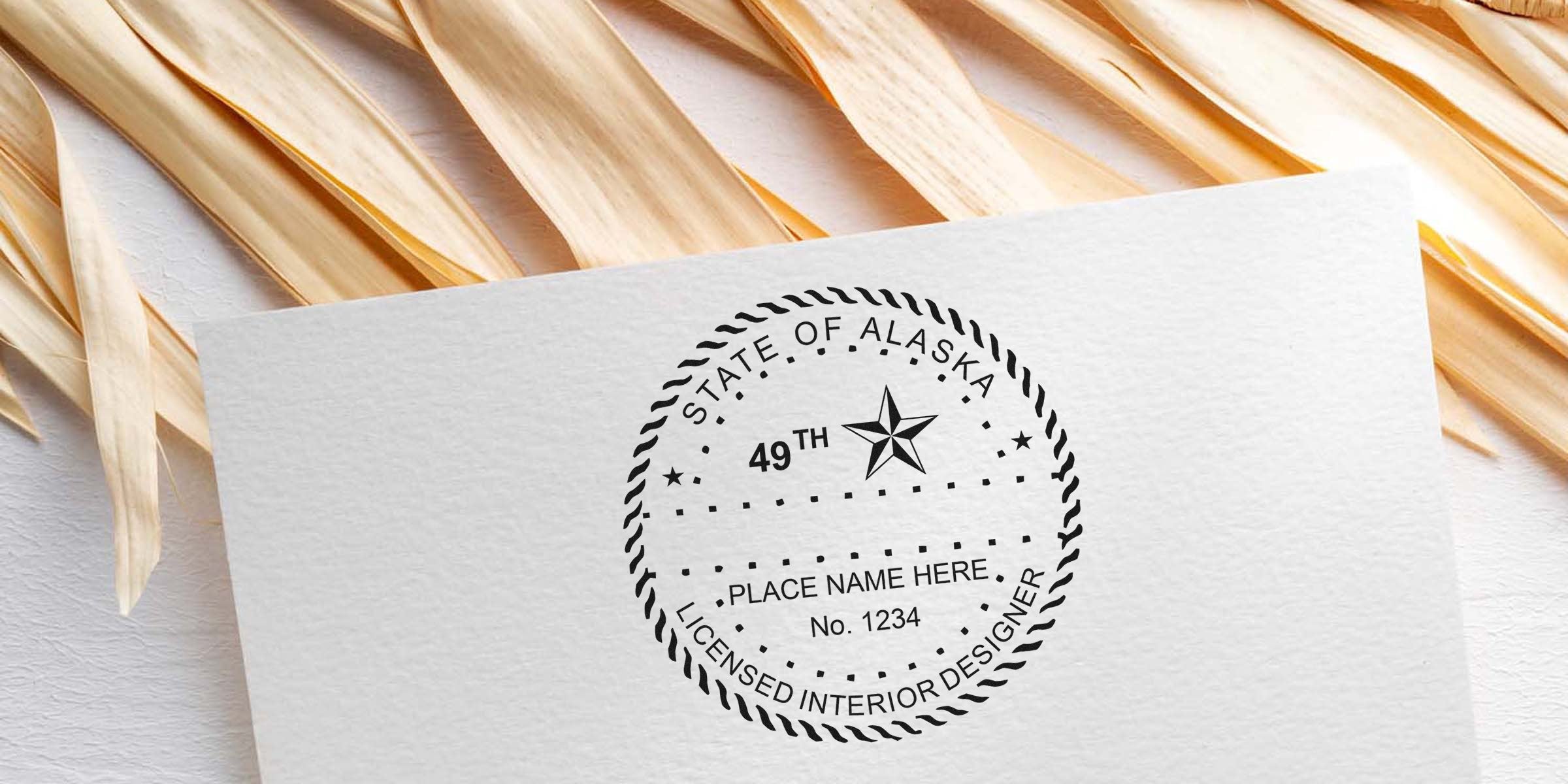 Alaska licensed interior designer stamp with 49th state emblem and customizable place name on textured paper, symbolizing interior design certification in Alaska.