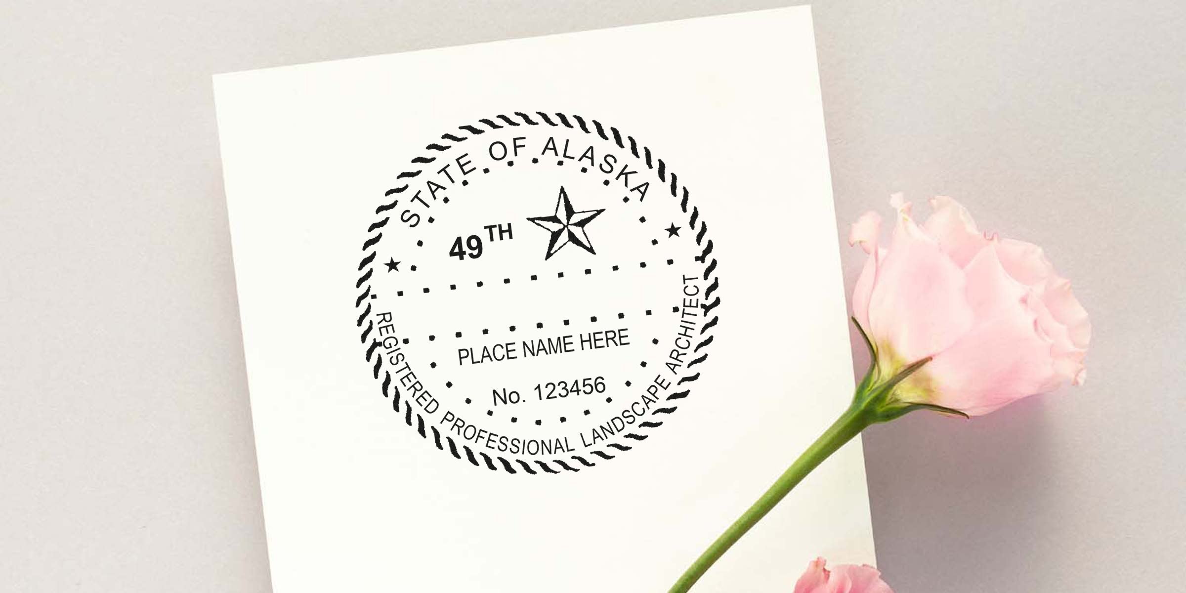 State of Alaska Landscape Architect stamp and embosser seal on white paper with a pink rose.