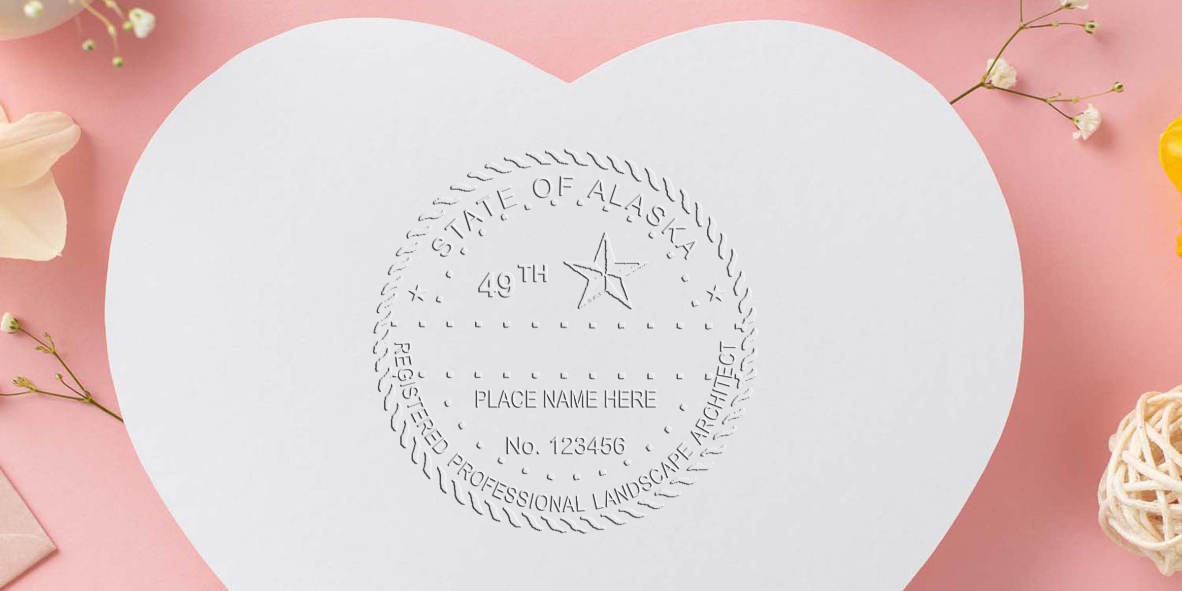 Heart-shaped paper with an embossed Alaska landscape architect seal on a pink floral background, highlighting the significance of selecting a landscape architect seal.
