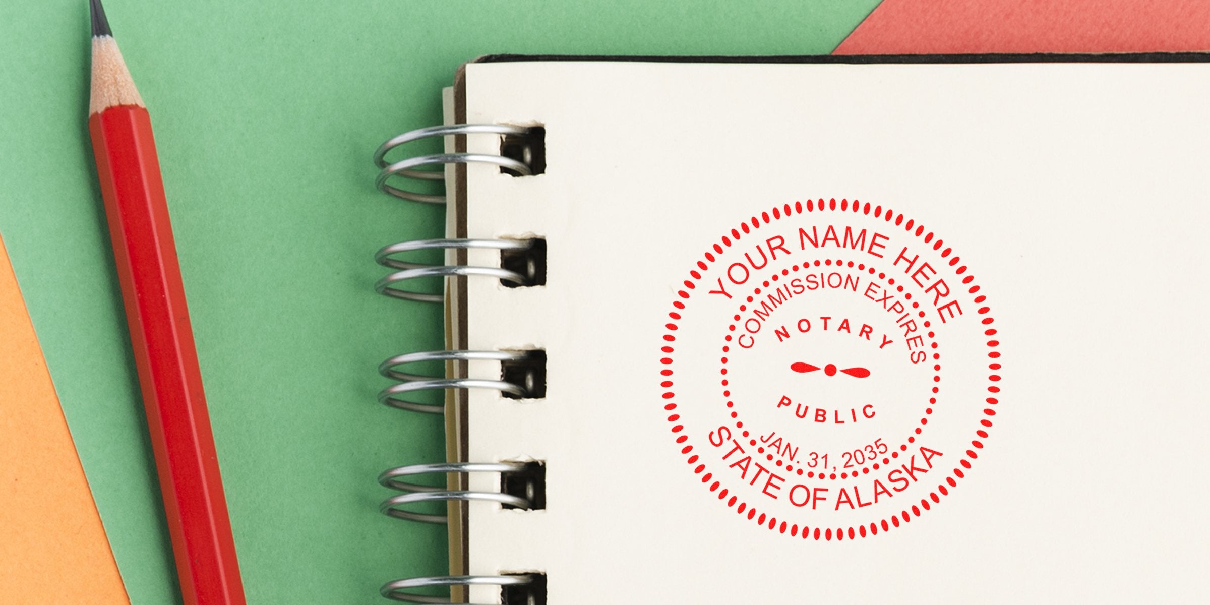 Alaska notary public stamp on notebook with red pencil, set against a colorful background featuring AK notary supplies and essentials.