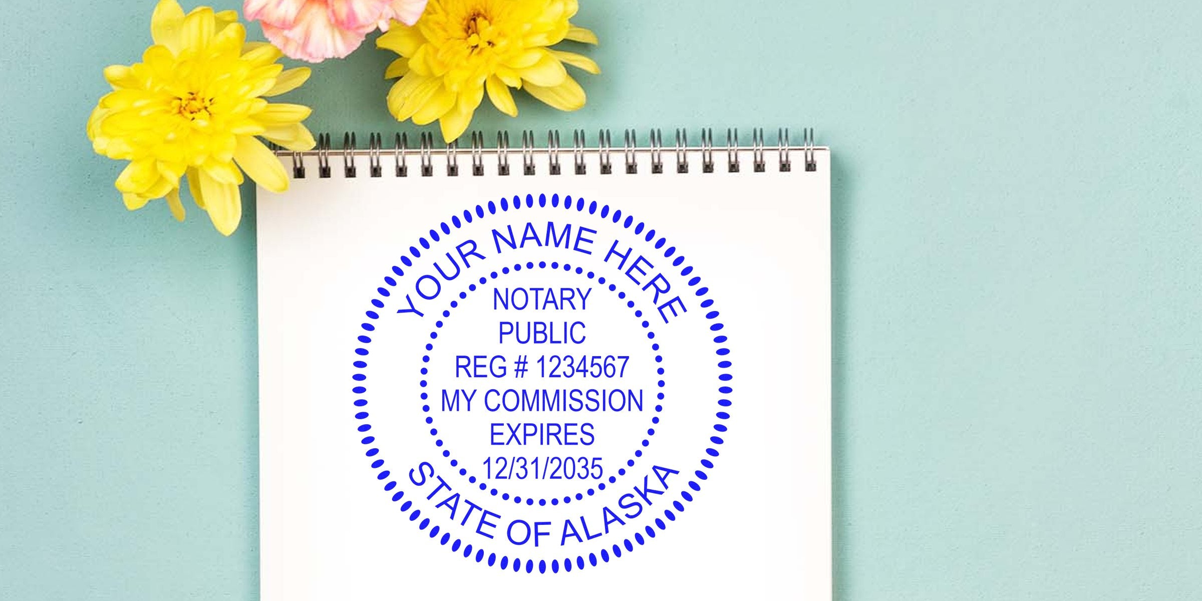 Notary Stamp AK on notebook with yellow flowers, showing Alaska notary public stamp and commission expiration date. Best Notary Stamp Alaska.