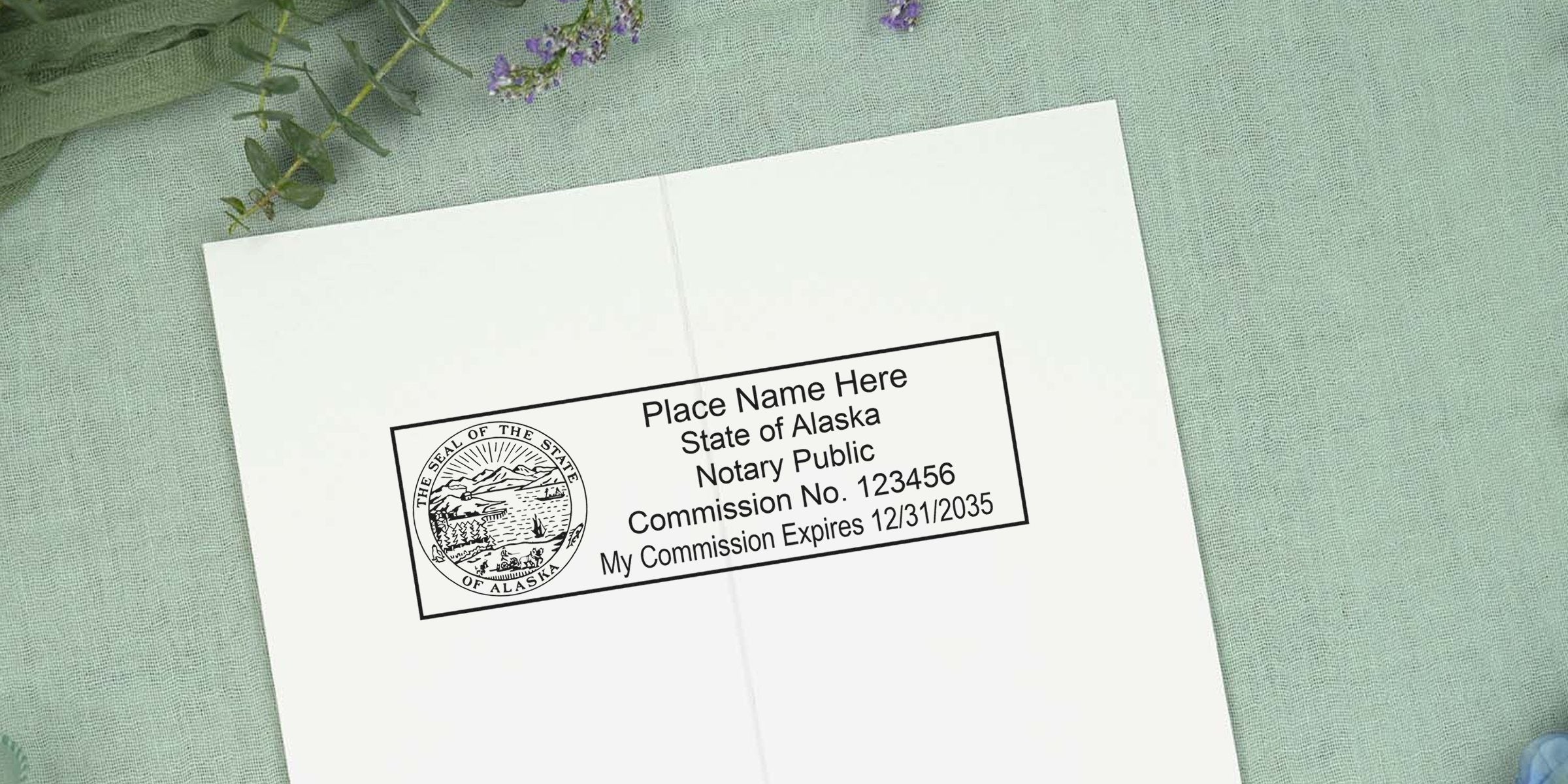 Notary Seal Alaska with notary public stamp, commission number, and expiration date on white paper. Buy your Alaska Notary Seal today.