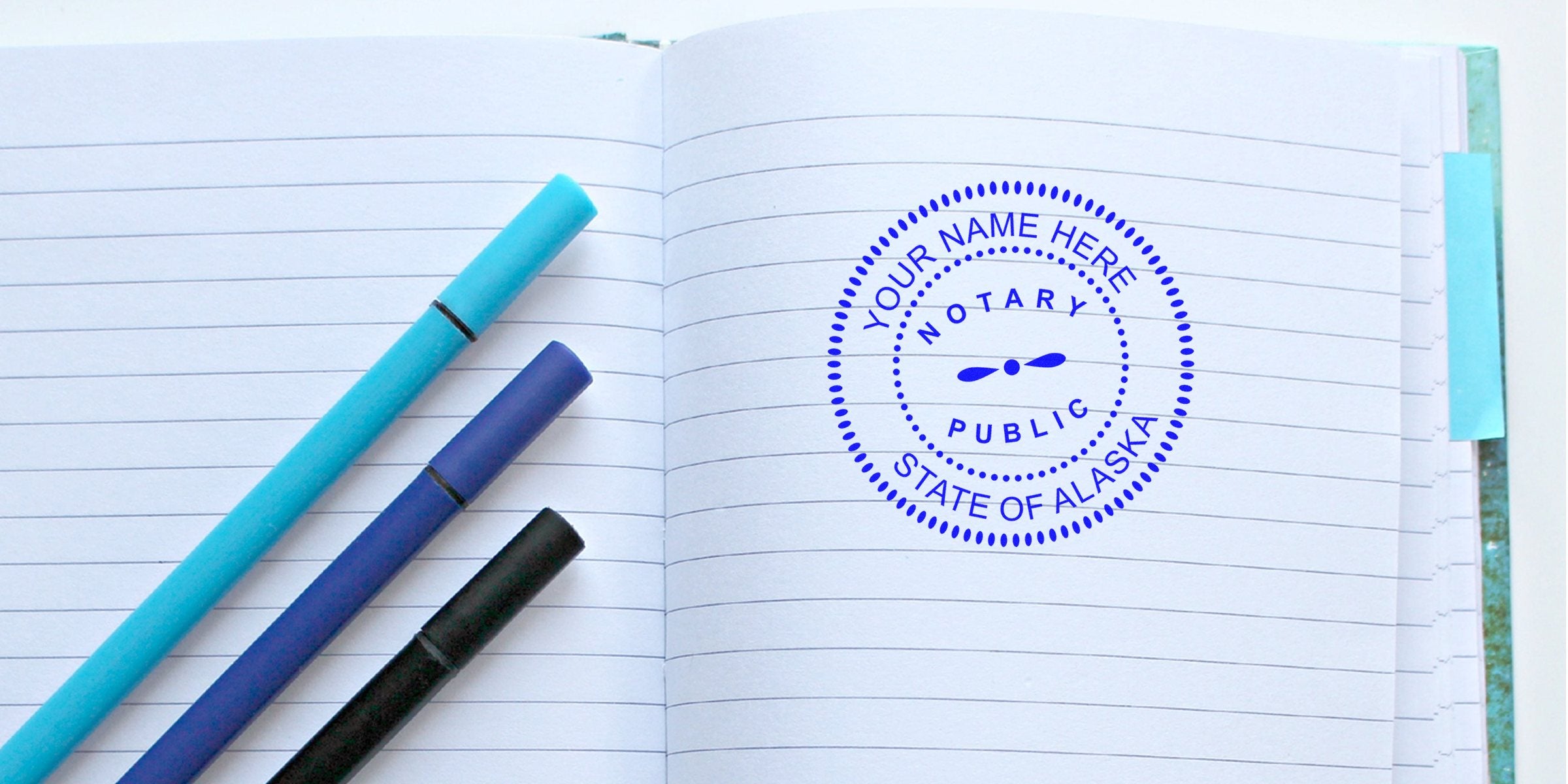 Alaska notary stamp on lined notebook with pens, official seal for document certification, emphasizing online notary services.