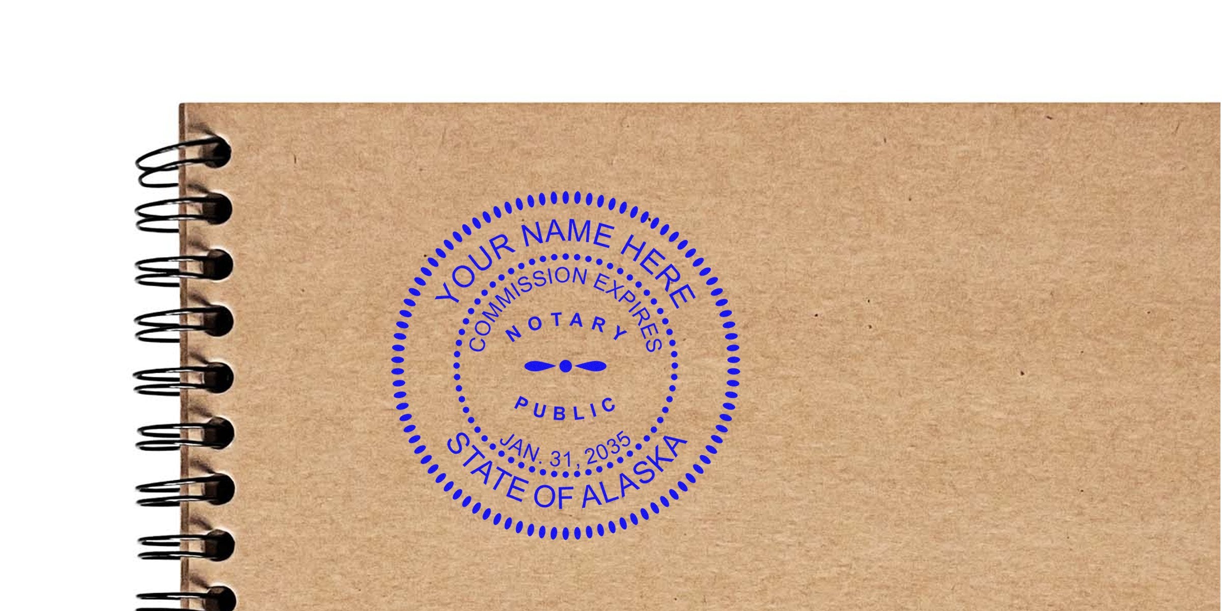 Alaska notary seal on brown notebook, commission expires Jan 31, 2035. Order your notary seal online today.