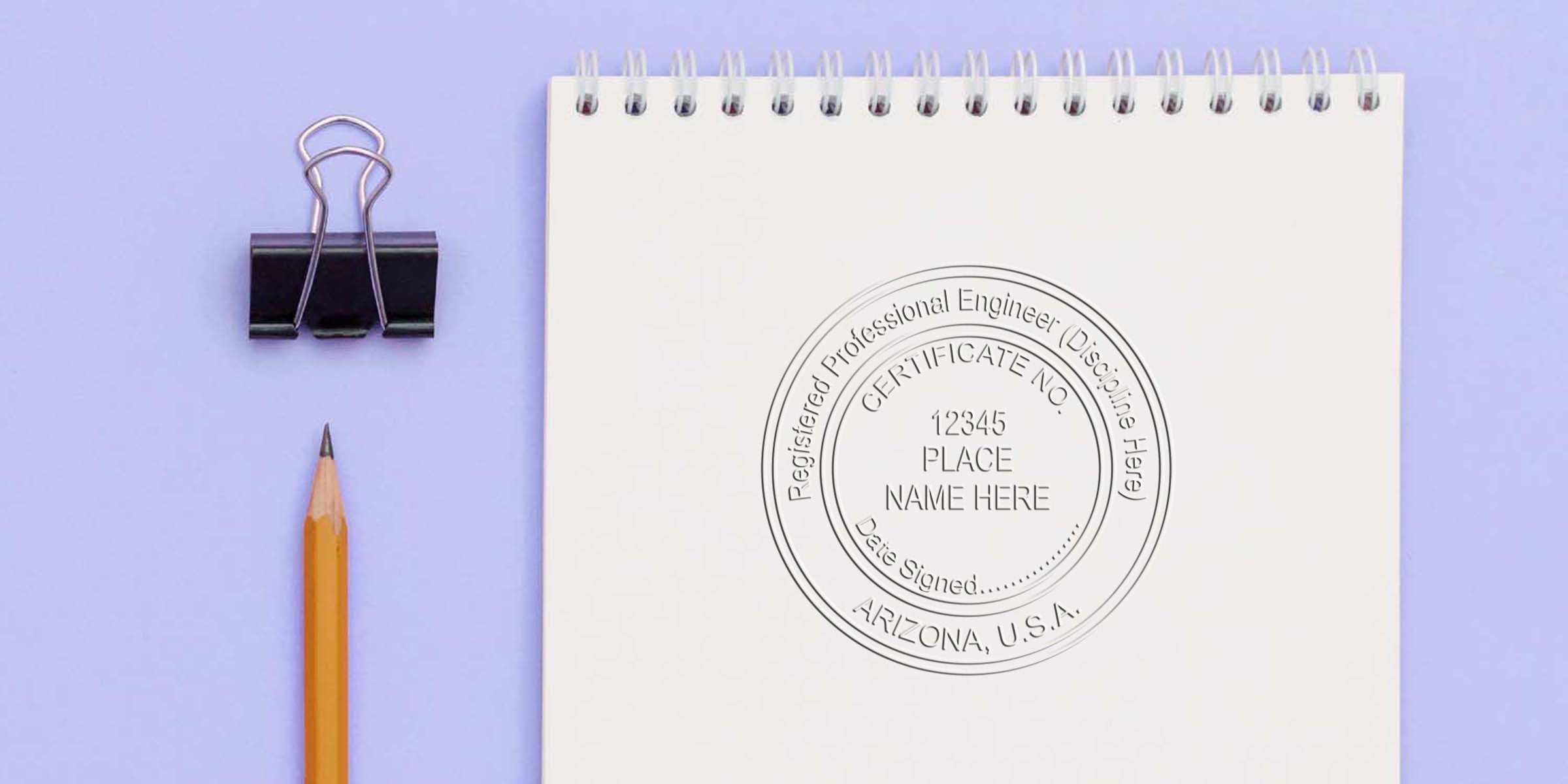 Arizona engineer stamp with registered professional engineer seal on white notebook, pencil, and binder clip against purple background, highlighting the engineer seal design.