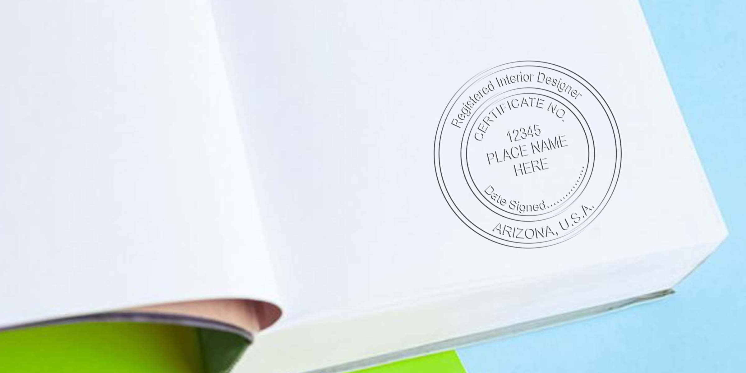 Embossed Arizona interior designer certification stamp on white paper with blue background, showing seal embossing guide.