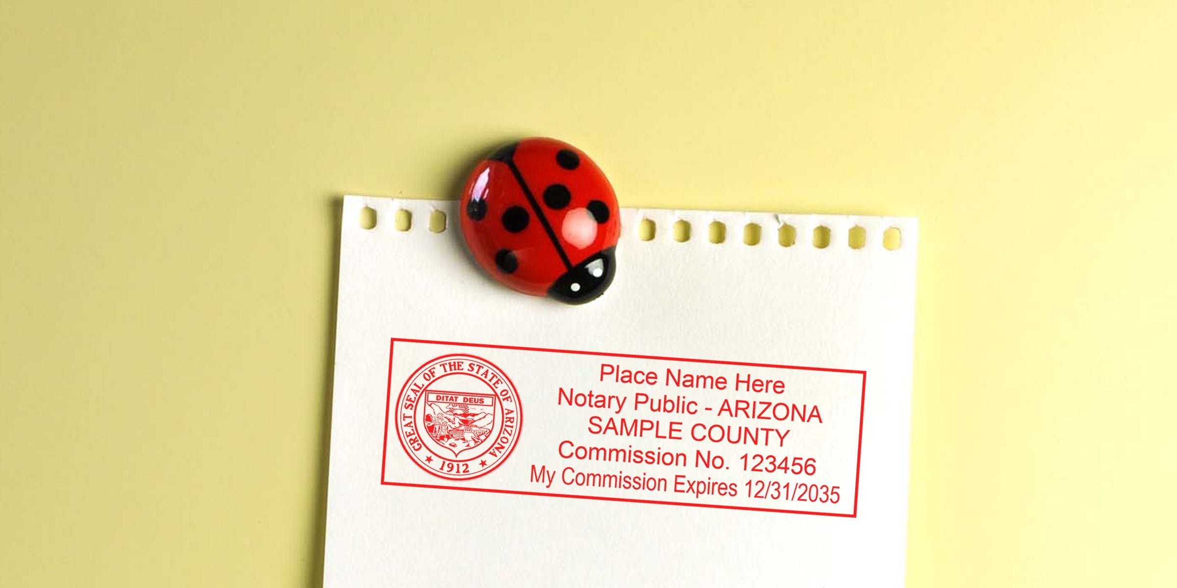 Arizona notary public stamp and seal on paper with a ladybug magnet, showing Arizona Notary Public requirements.