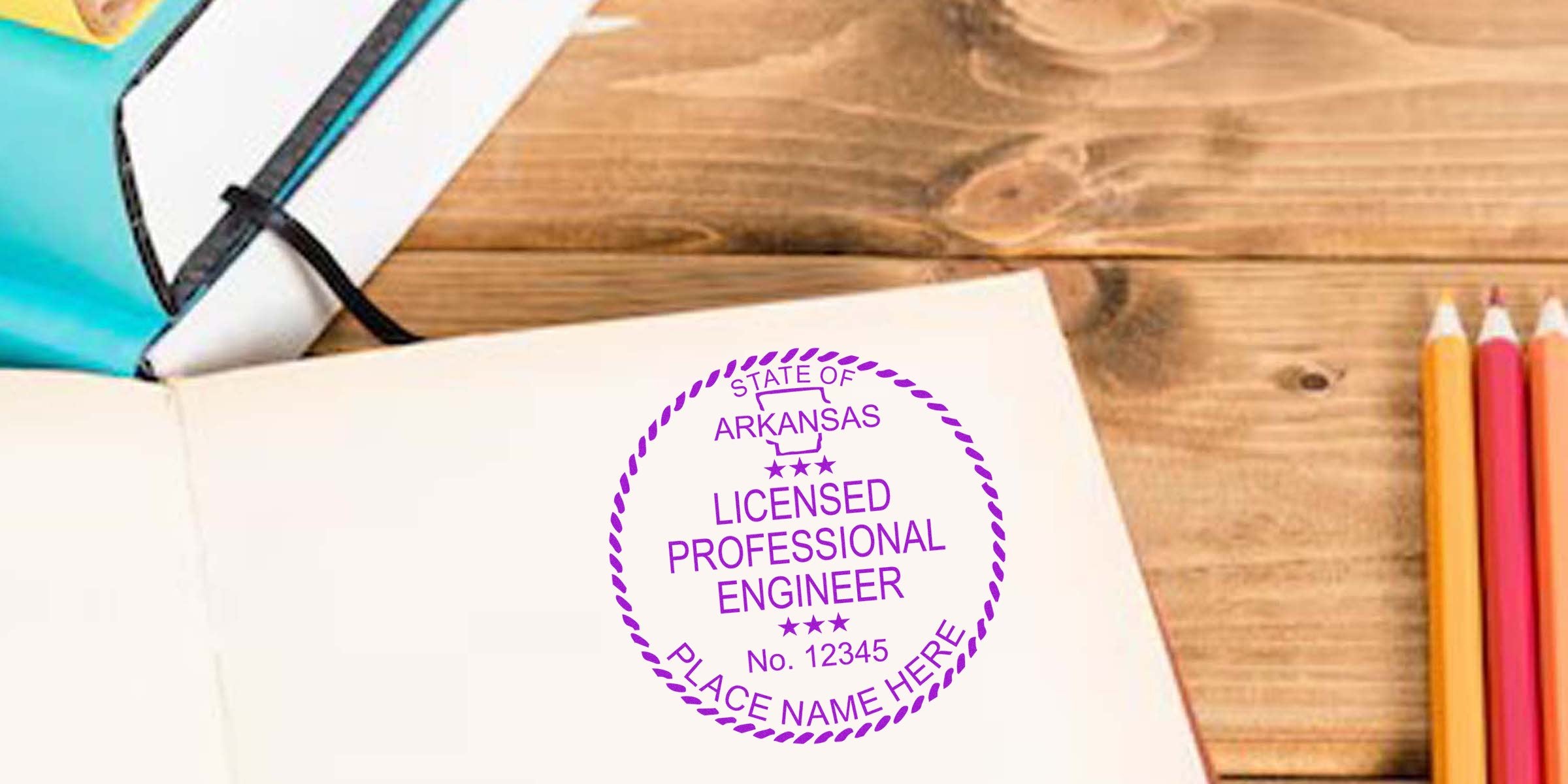 Arkansas engineer stamp on open notebook with colored pencils and planner on wooden desk, highlighting professional engineer license.