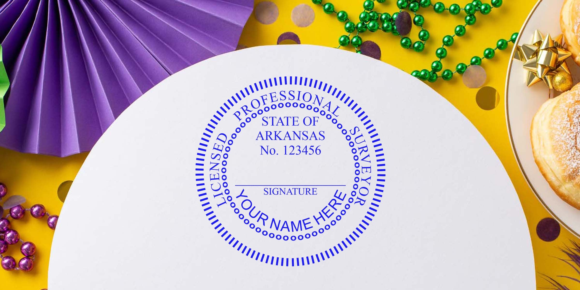 Arkansas land surveyor stamp on white paper with Mardi Gras decorations and donuts background, showing Arkansas licensed professional surveyor seal; purchase land surveyor stamp online.
