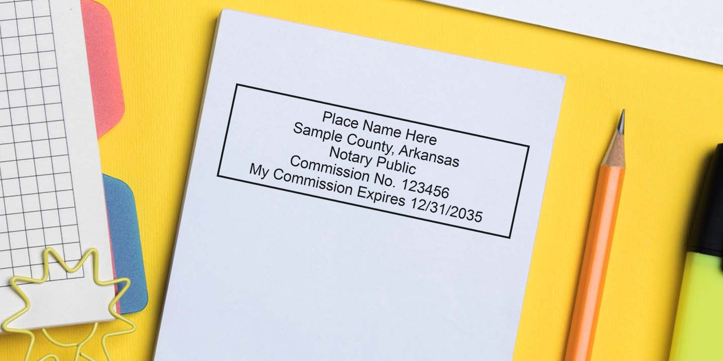 Arkansas notary public commission certificate on white paper with pencil and highlighter on yellow background, showing AR notary and reliable notary stamps for notary services.