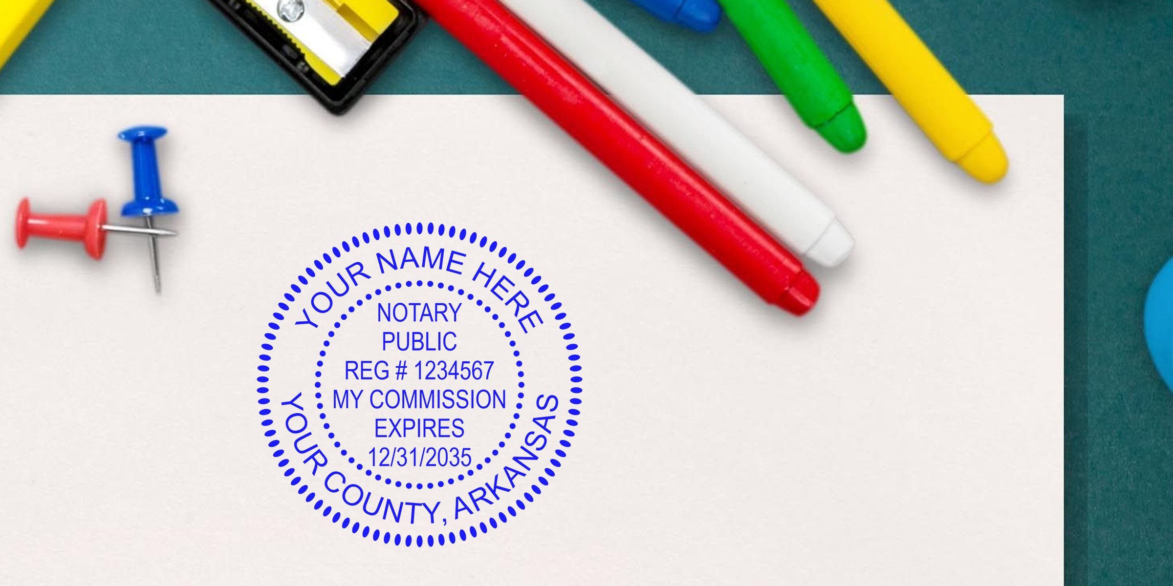 Arkansas notary stamp with official seal on white paper, surrounded by colorful markers and push pins, customized for Arkansas county commission expiration.