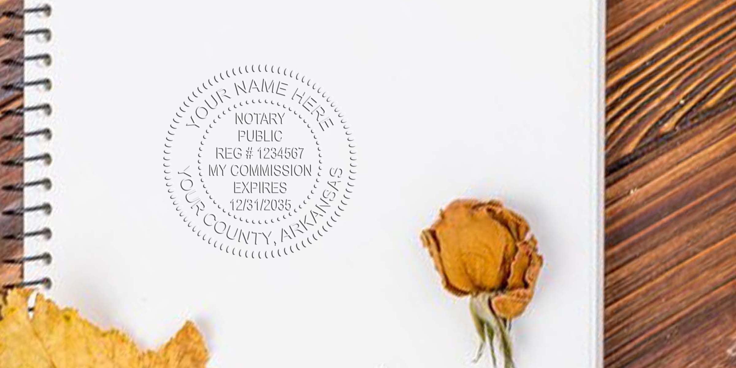 Notary Seal Arkansas stamp on white notebook with dried rose and autumn leaf on wooden table, showcasing essential Notary Supplies Arkansas.