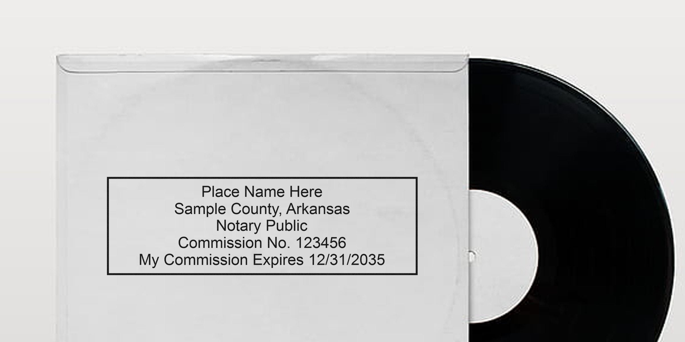 Black vinyl record partly in white paper sleeve showing Arkansas notary seal and stamp with commission and expiration dates visible.