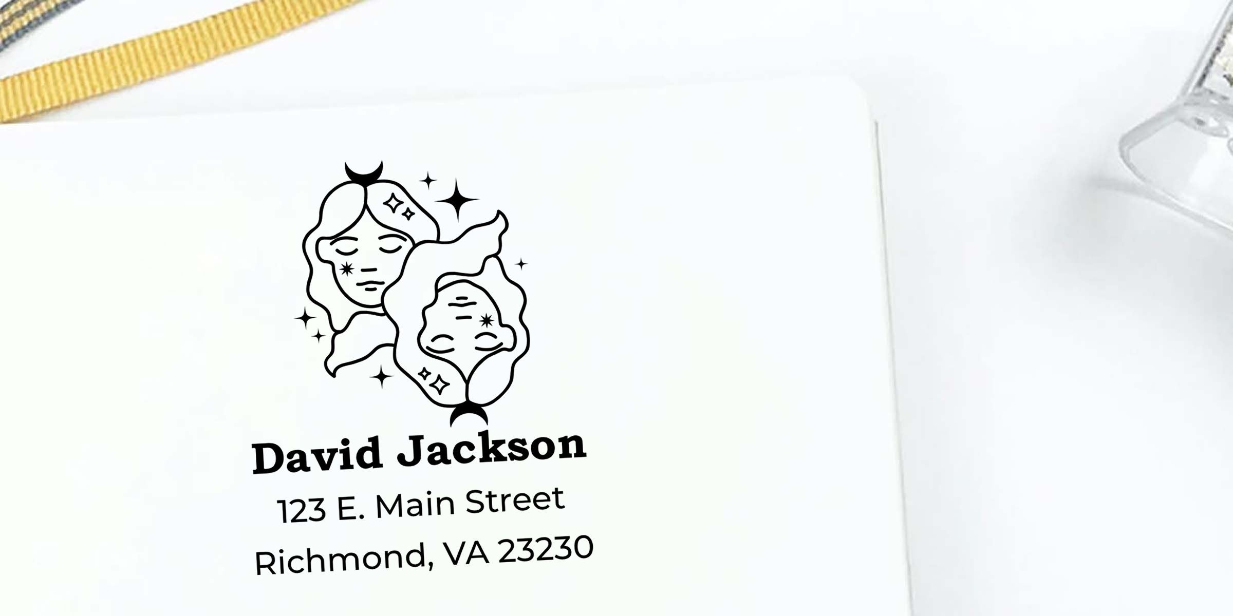 Custom personalized gift bag with minimalist twin face logo and the name David Jackson, 123 E. Main Street, Richmond, VA 23230 on a white background