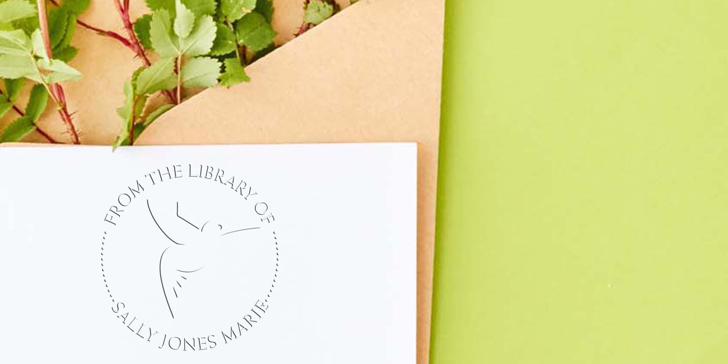 Personalized bookplate on white stationery with botanical leaves, featuring “From the Library of Sally Jones Marie” on a green background