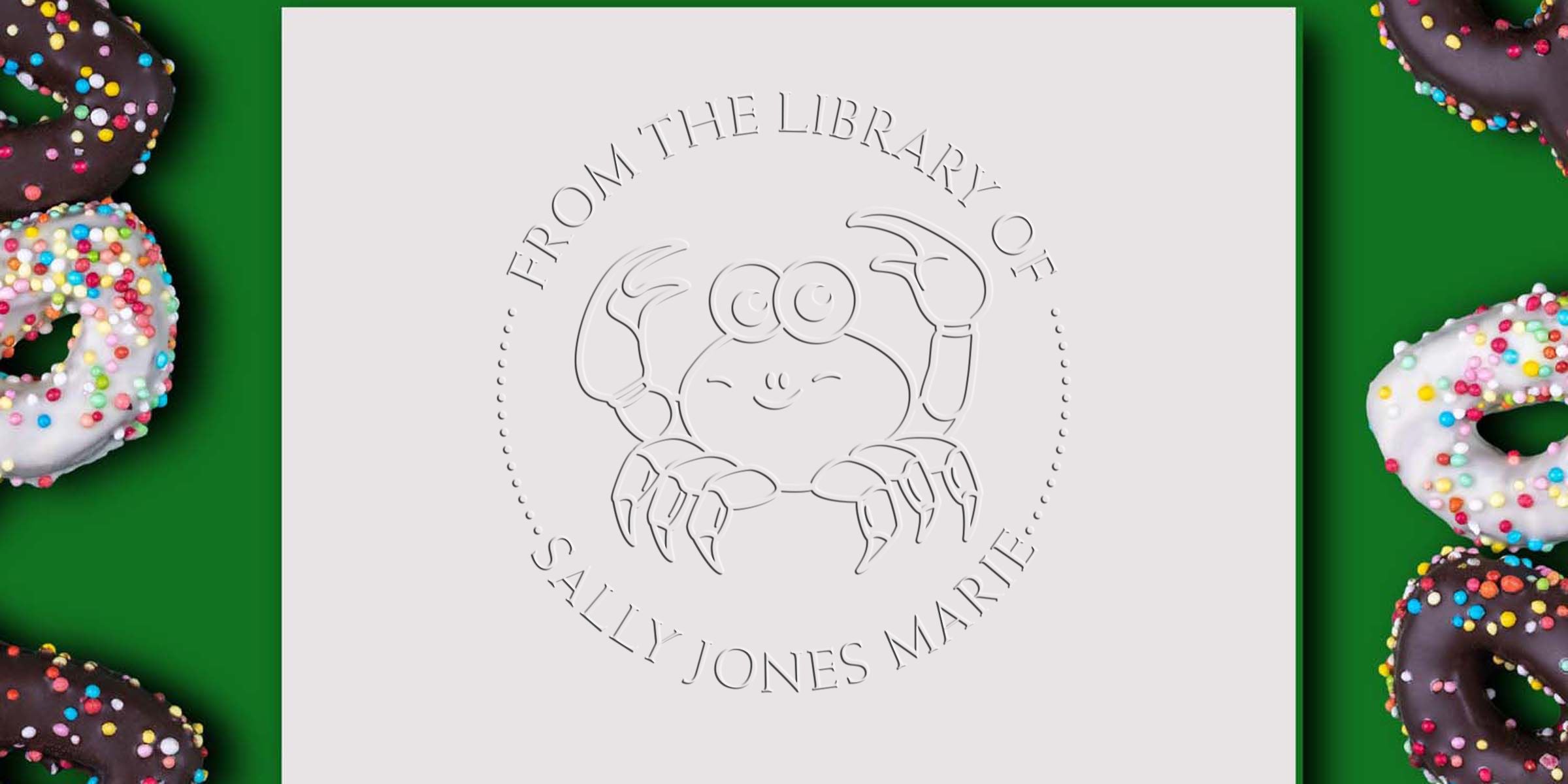 Custom library stamp design with a smiling crab logo and the text “From the Library of Sally Jones Marie,” framed by chocolate and white sprinkle donuts on a green background