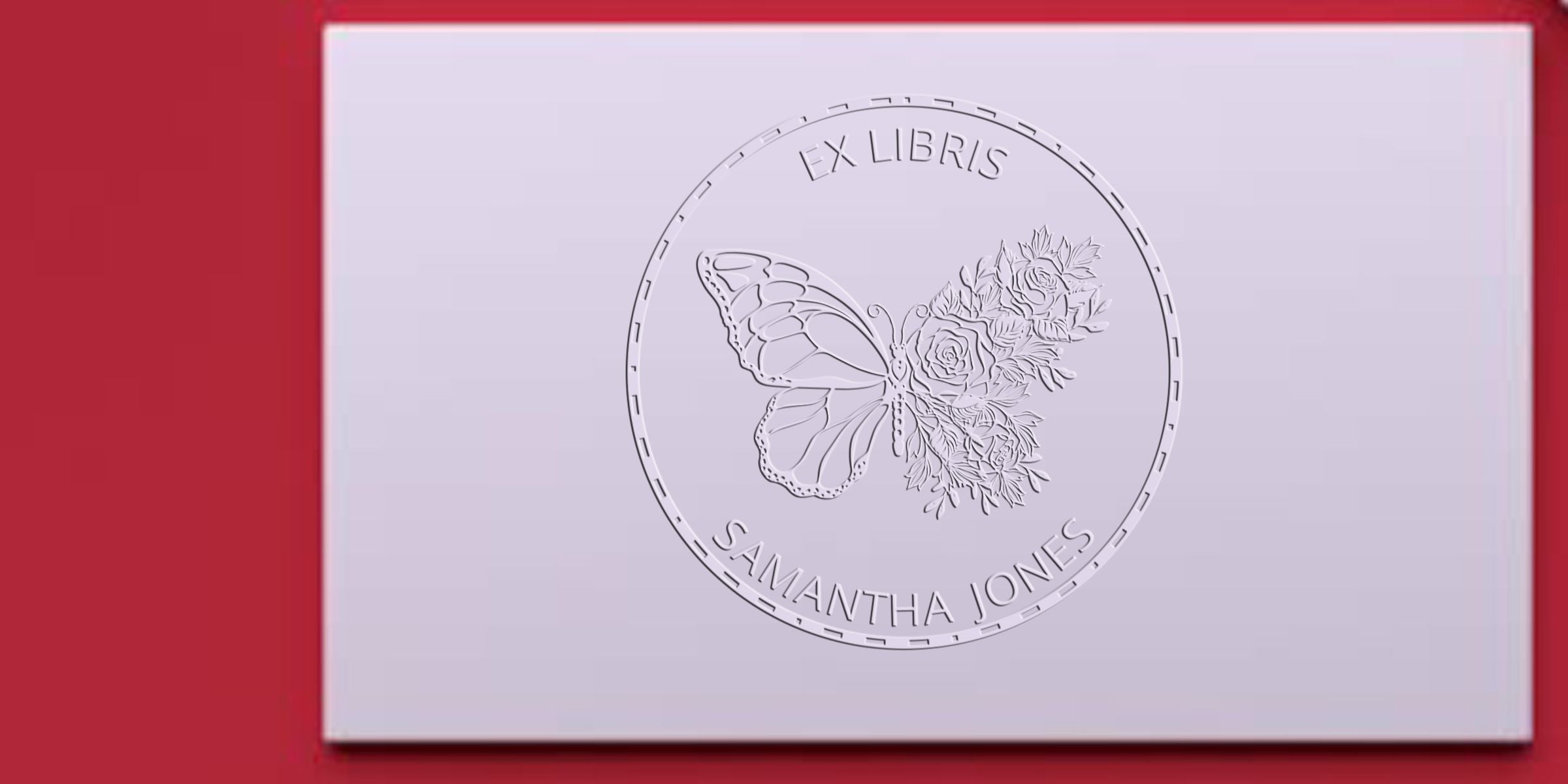 Embossed butterfly and floral ex libris bookplate with the name Samantha Jones on a white card against a red background