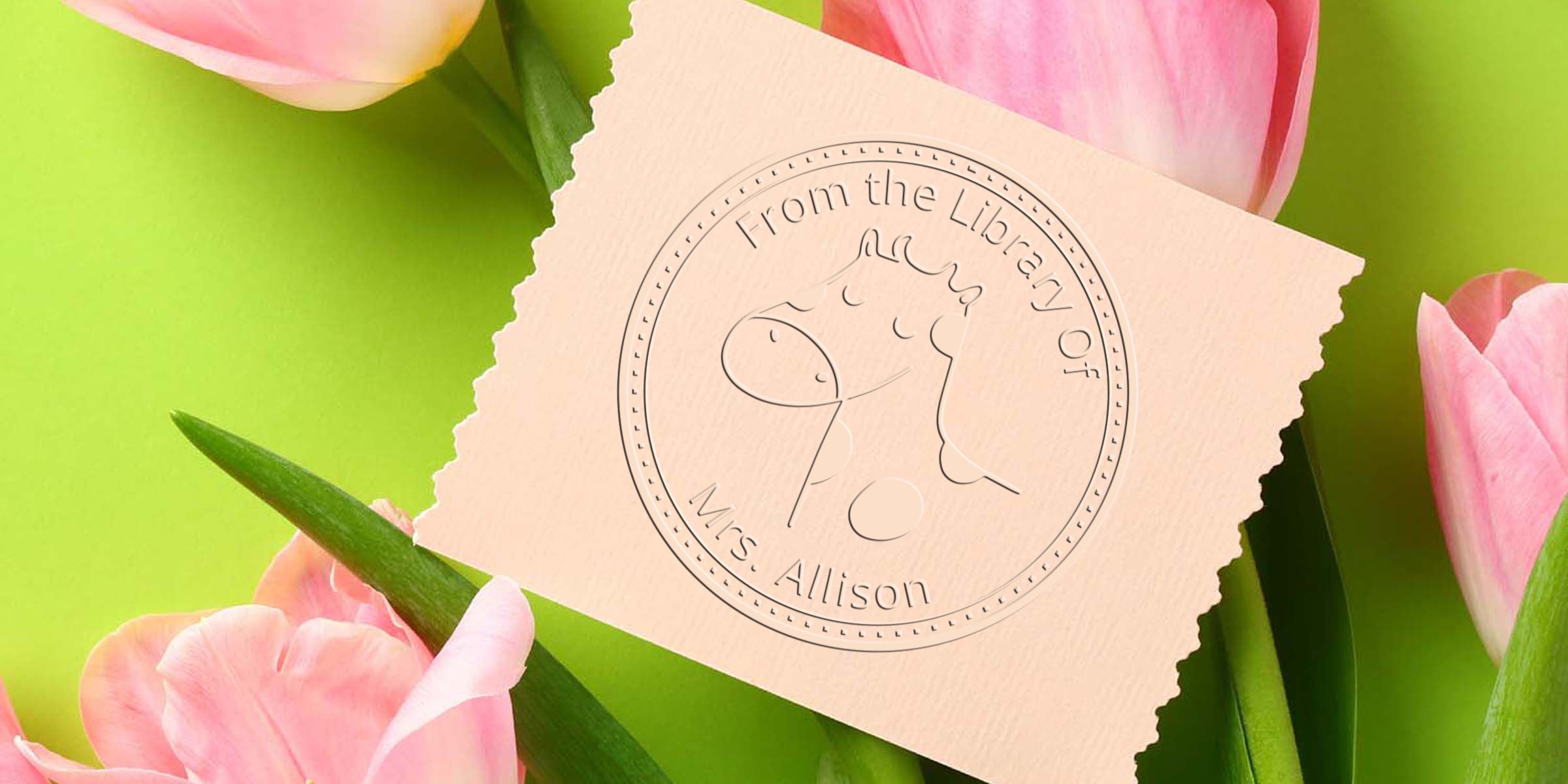 Pink tulips with a custom embossed library stamp reading “From the Library of Mrs. Allison” on a peach paper card against a bright green background.