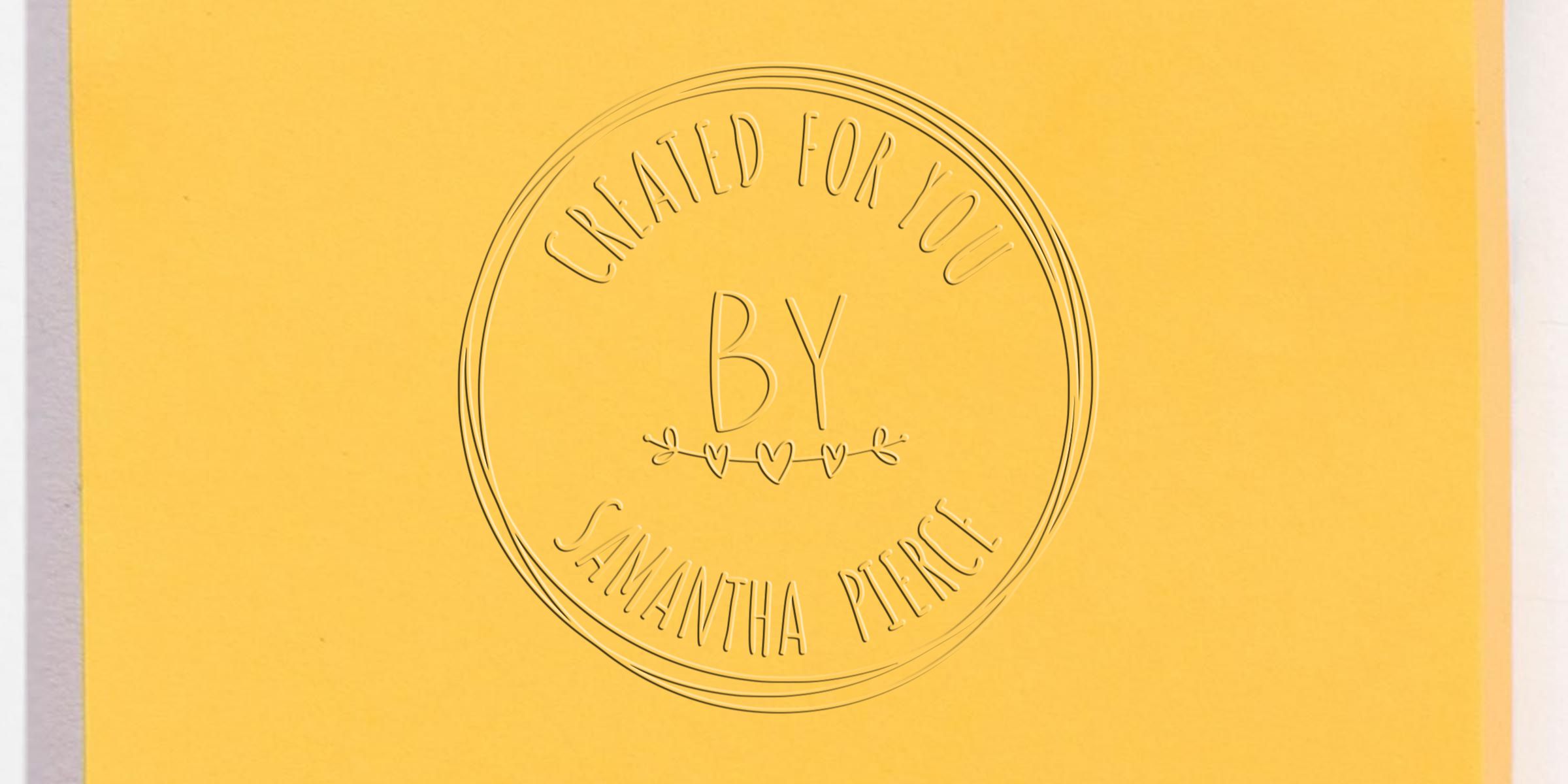 Yellow embossed branding card with circular logo reading “Created for You by Samantha Pierce” and “BY” in the center on a minimalist background