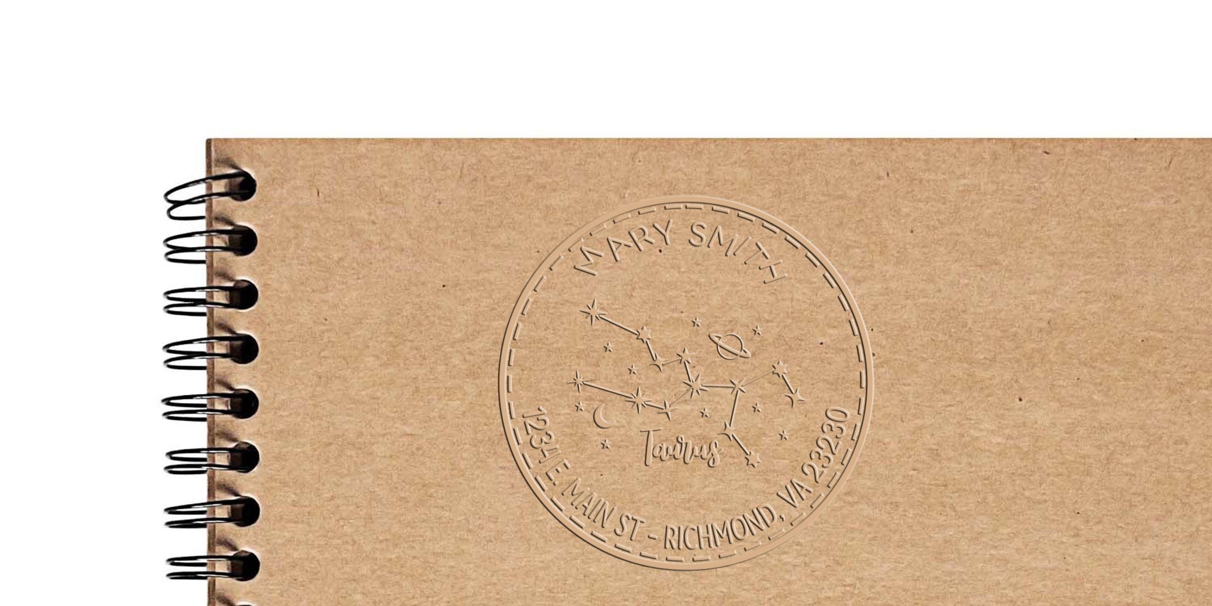 Personalized kraft spiral notebook with Taurus constellation design, Mary Smith name stamp, and Richmond, VA address engraving