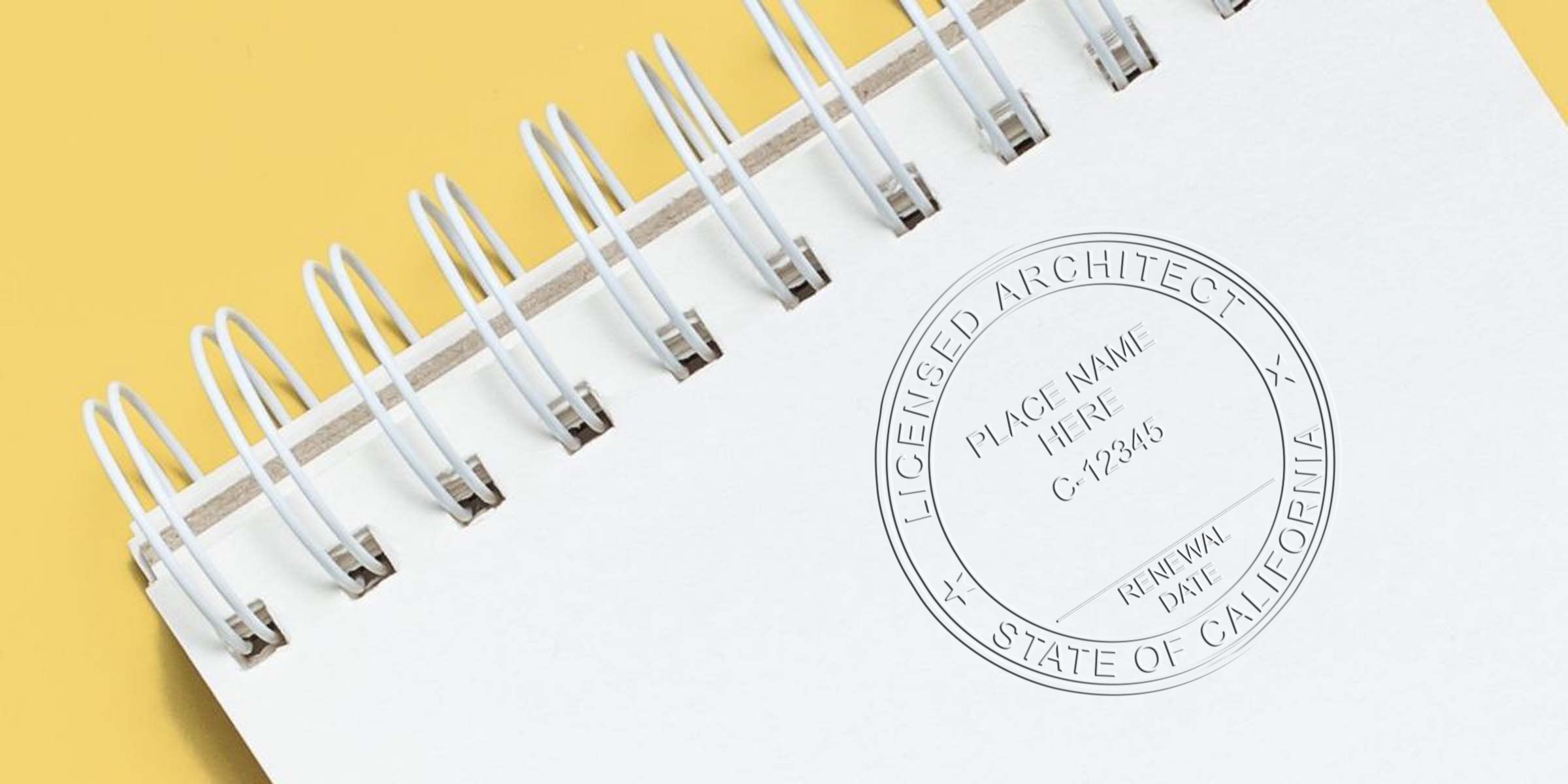 California architect stamp on white spiral notebook with yellow background, representing project approval and license renewal.