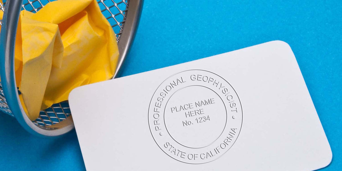 Professional geophysicist license card with California geologist stamp and wastebasket holding crumpled yellow paper on blue background, emphasizing California geologist stamp requirements.