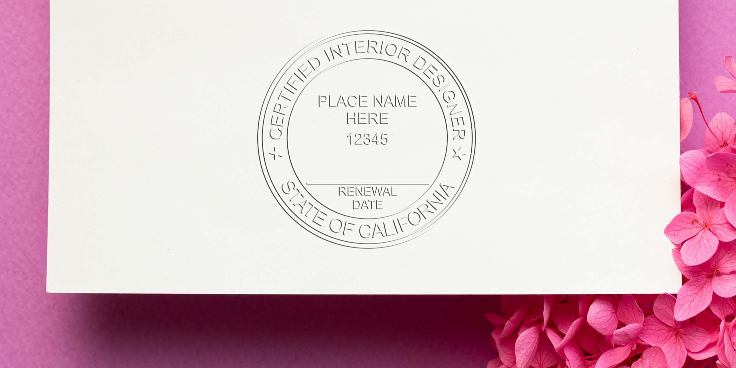 Certified interior designer seal on white paper with pink flowers, displaying California interior designer rules, seal requirements, and certification renewal date.