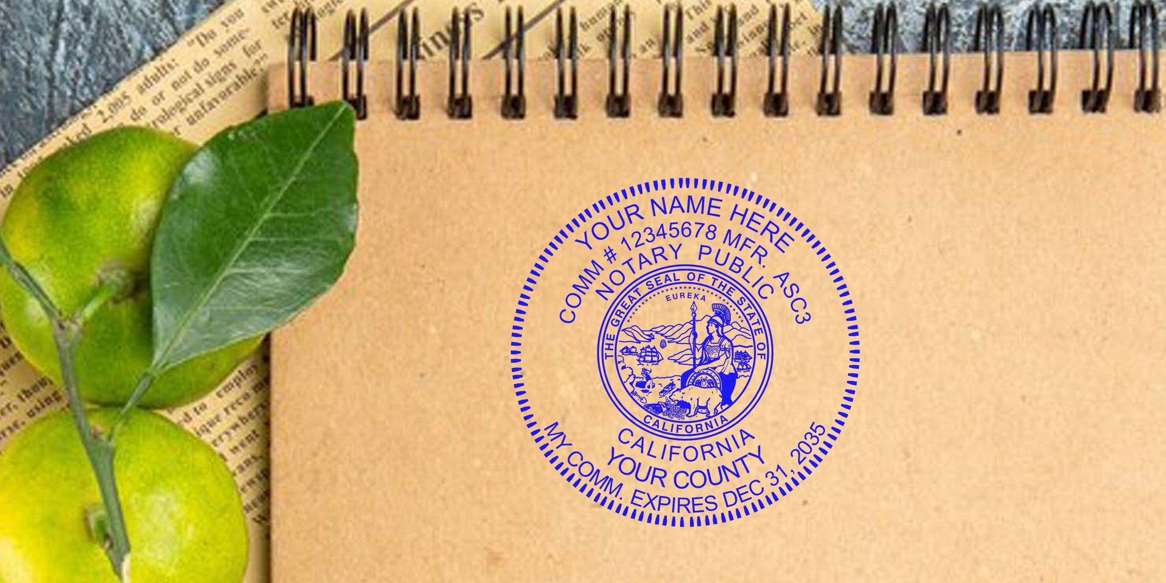 CA notary stamp on brown notebook with green citrus fruits and newspaper background, showcasing a custom California notary stamp design.
