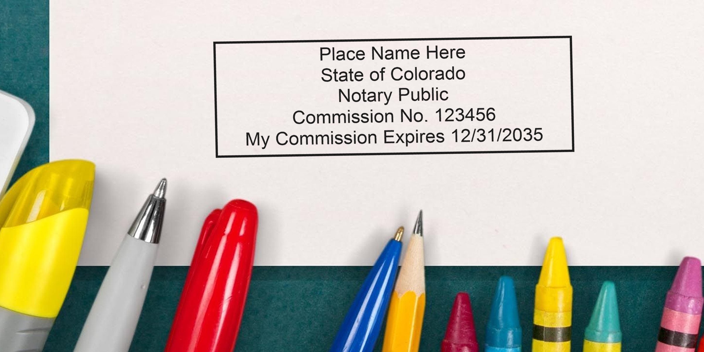Colorado notary stamp on paper, surrounded by colorful pens and crayons, symbolizing a Colorado notary public commission.