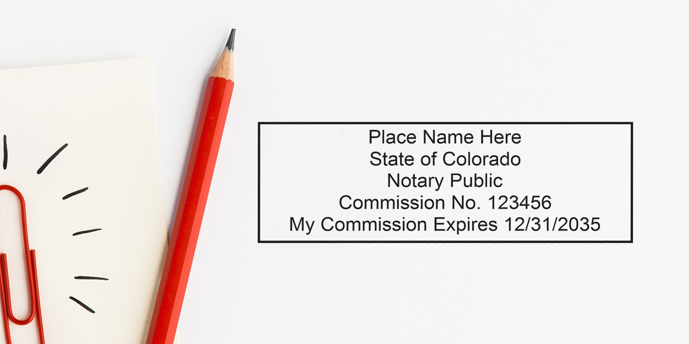 Red pencil and paperclip next to Colorado notary public commission stamp expiring 2035, showcasing Colorado notary stamp offers and notary seal discounts.
