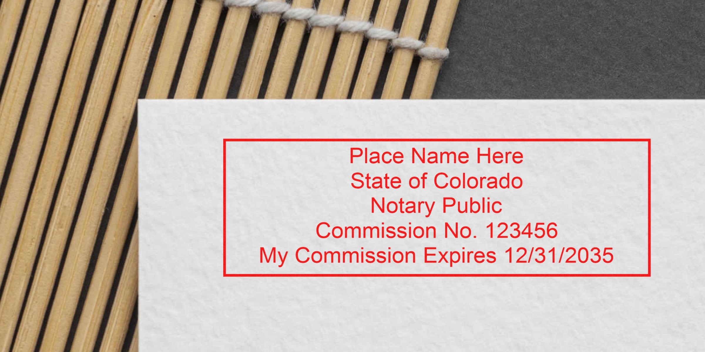 Colorado notary stamp with CO seal, commission number, and expiration date on white paper, showcasing the importance of the notary seal for authenticating official documents.