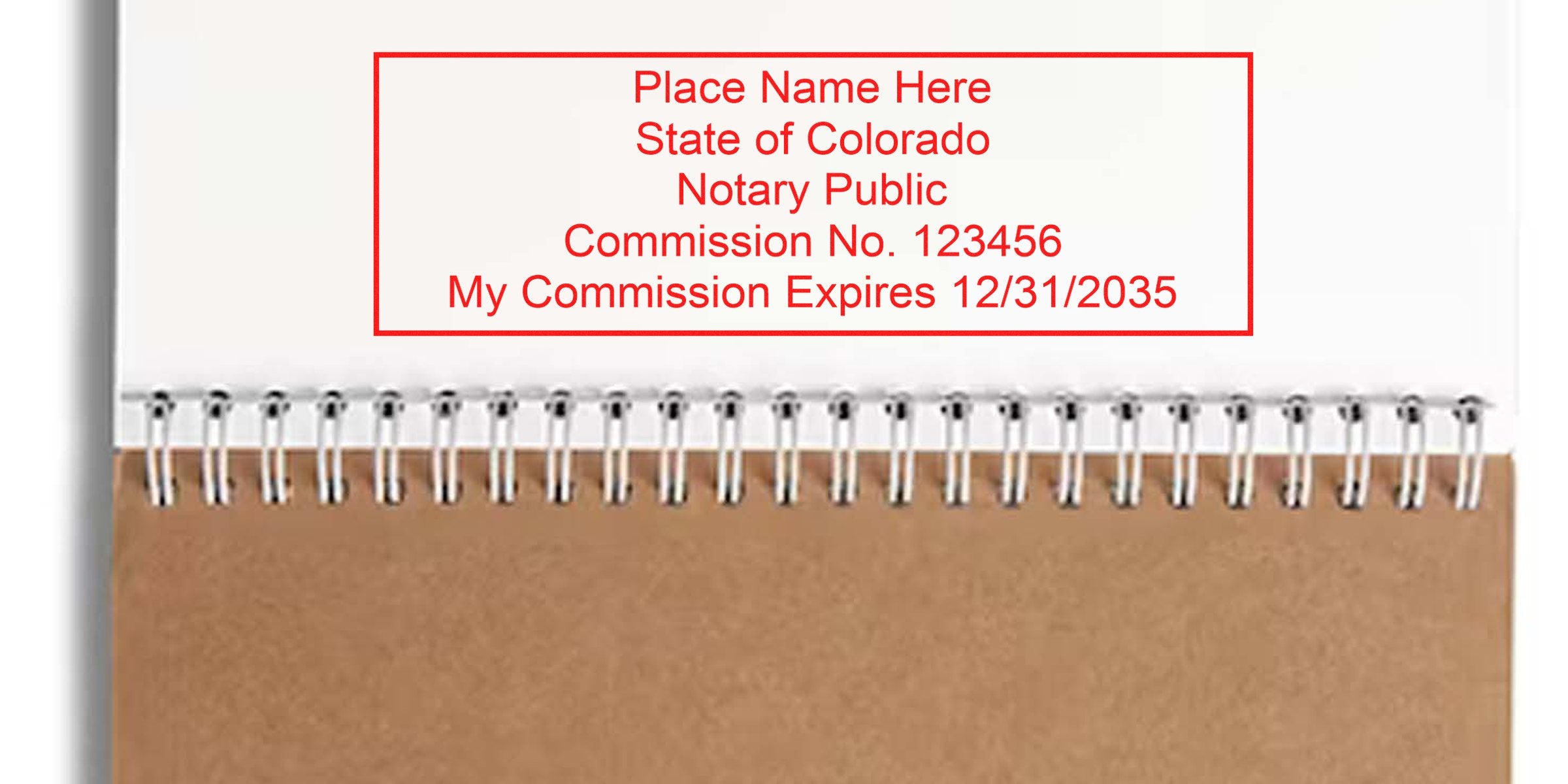 Spiral notebook with Colorado notary kit stamp, showing commission and expiration date, highlighting new notary supplies.
