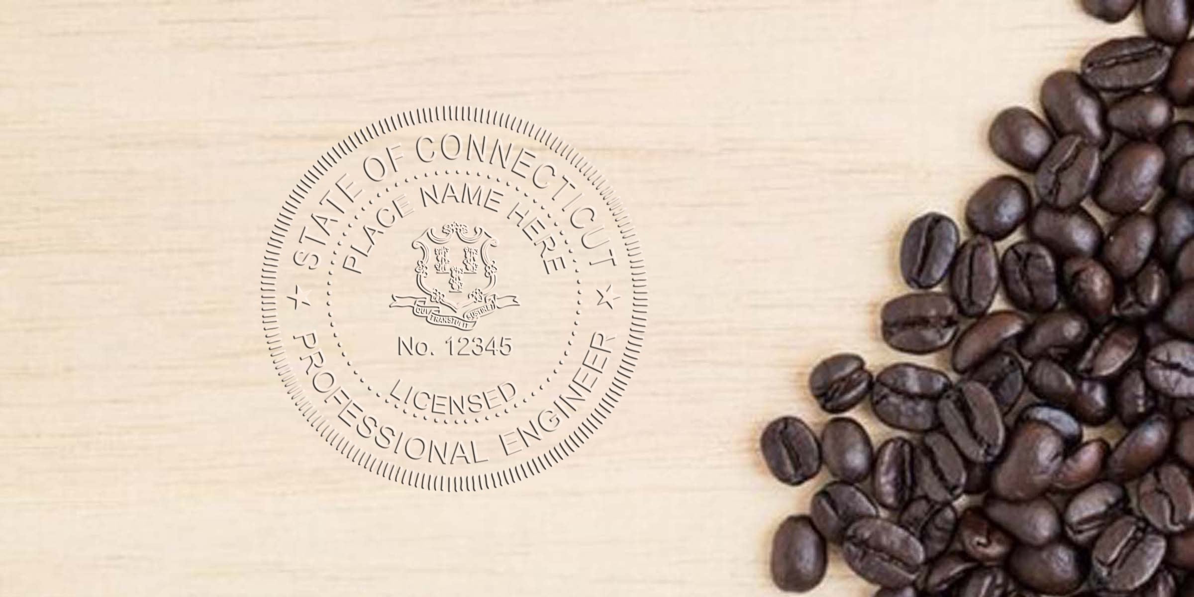 Embossed Connecticut professional engineer seal on wood next to coffee beans, showing CT engineer stamp rules and requirements.