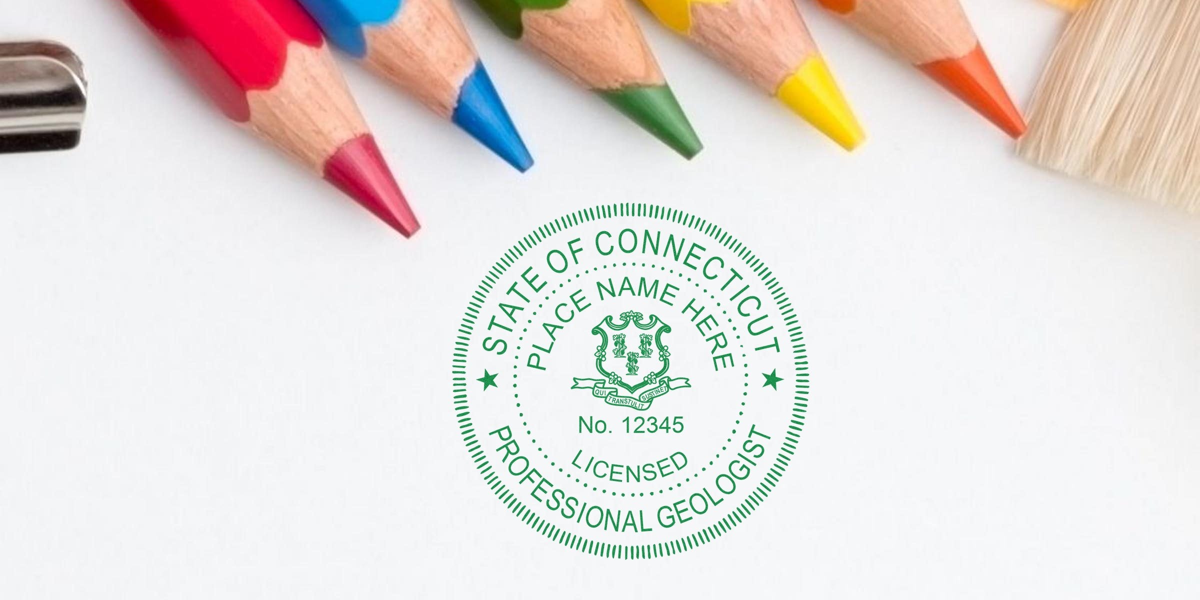 Connecticut licensed professional geologist seal with colored pencils and paintbrush on white, showcasing Connecticut geologist stamp and related regulations.